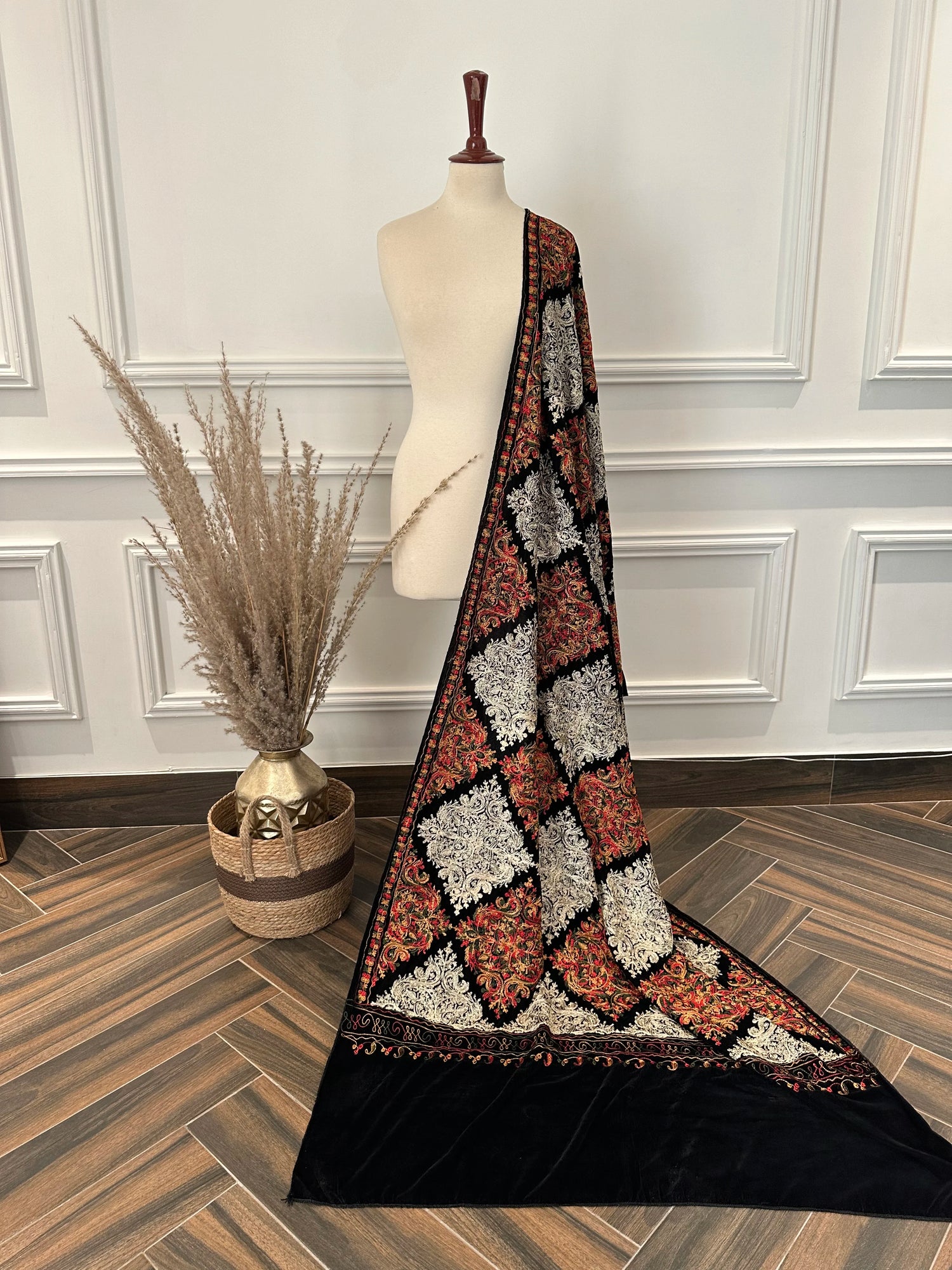 A black velvet shawl adored with multi-thread embroidery, highlighting chic modern style and fashionable aesthetic.