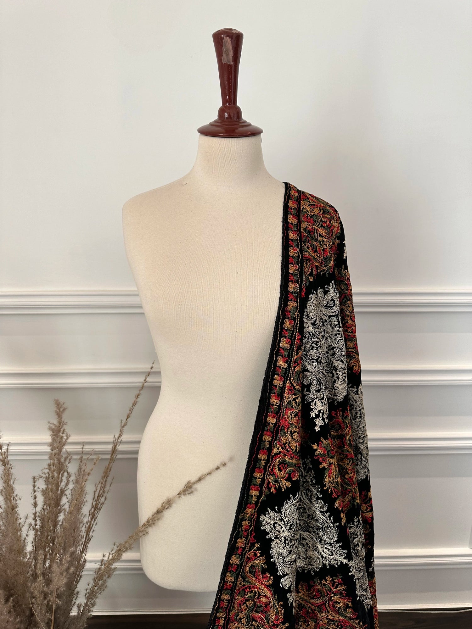 A black velvet shawl adored with multi-thread embroidery, highlighting chic modern style and fashionable aesthetic.