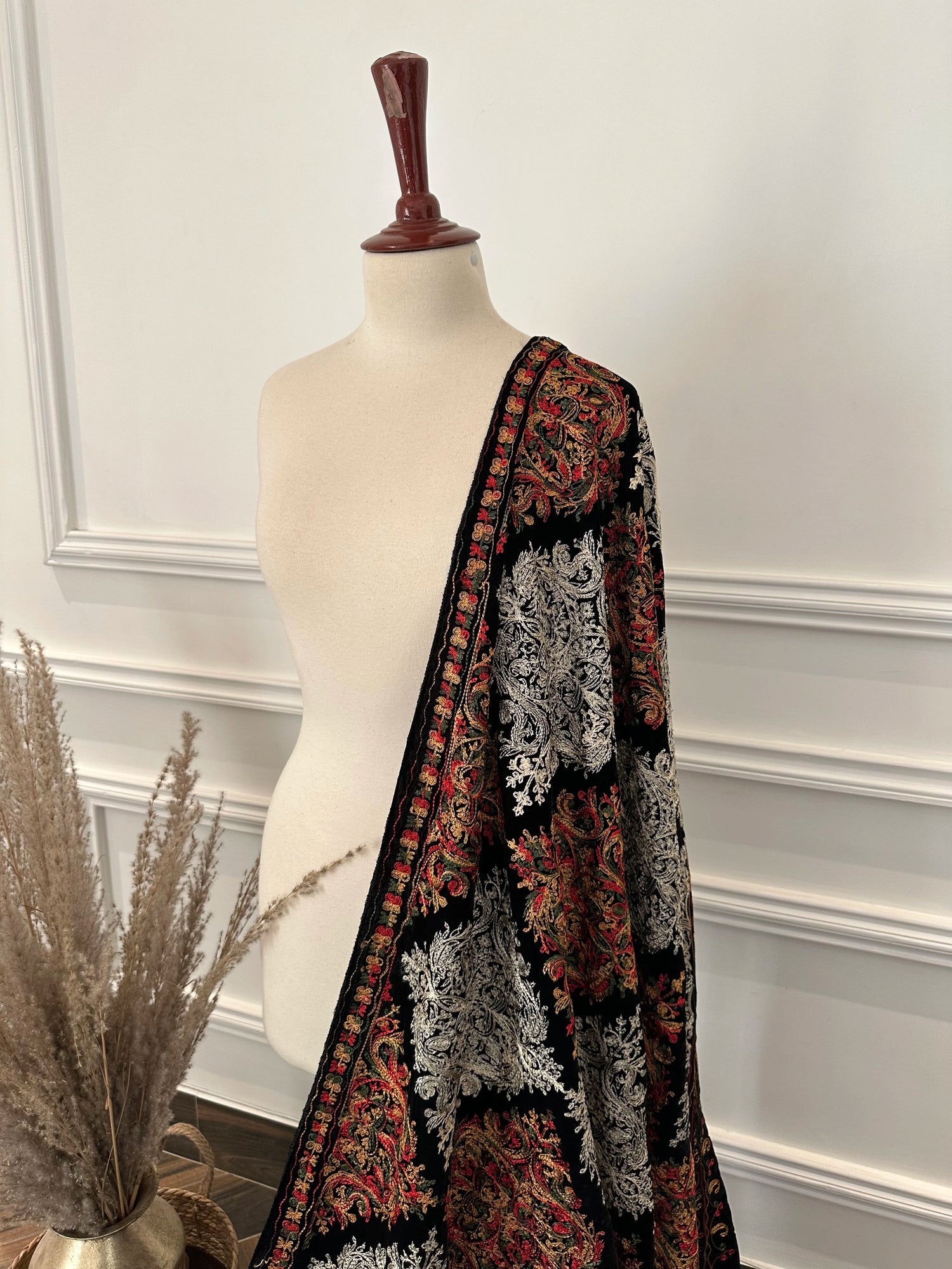 A black velvet shawl adored with multi-thread embroidery, highlighting chic modern style and fashionable aesthetic.
