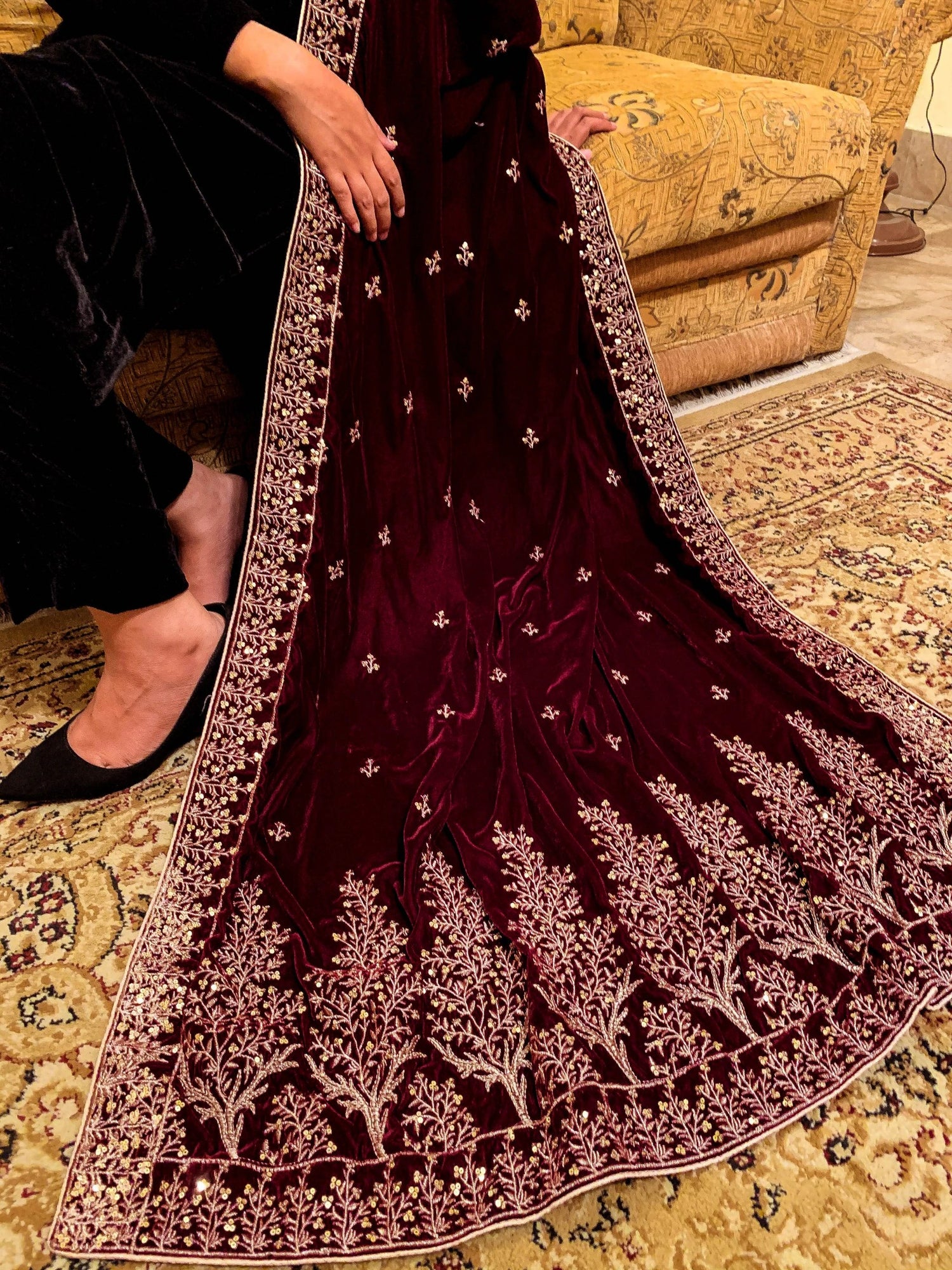 Luxurious velvet shawl featuring intricate tila and sequin embroidery with tree motifs on palu, detailed borders on all sides, and finished with a rich jamawar palta
