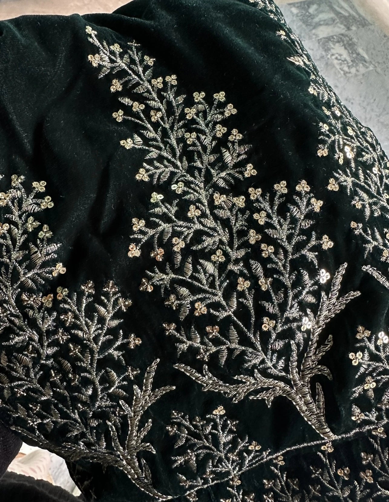 Luxurious velvet shawl featuring intricate tila and sequin embroidery with tree motifs on palu, detailed borders on all sides, and finished with a rich jamawar palta