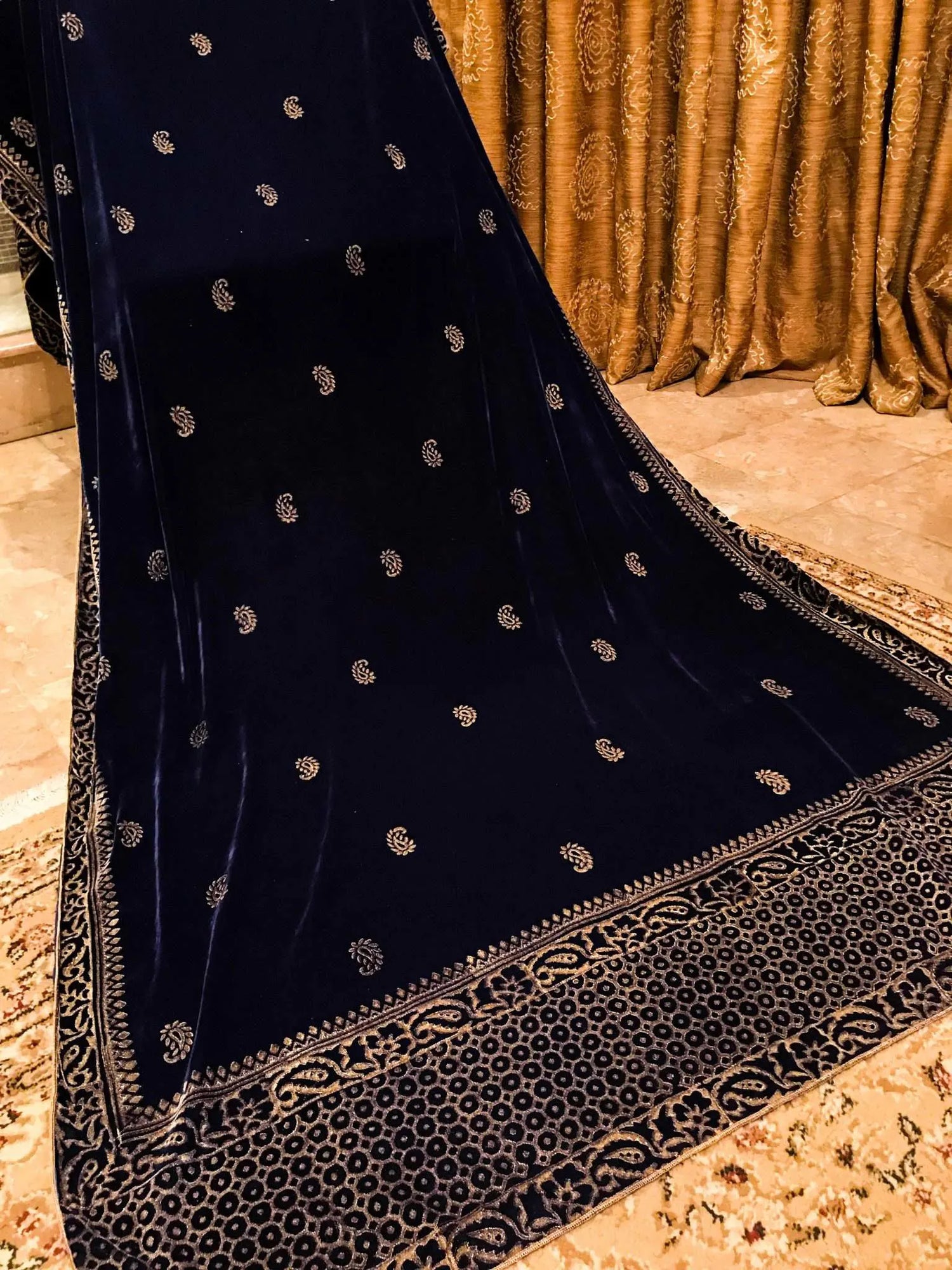Luxurious velvet shawl detailed with gold block and screen printed designs. Showing a graceful fusion of heritage artistry and elegance.