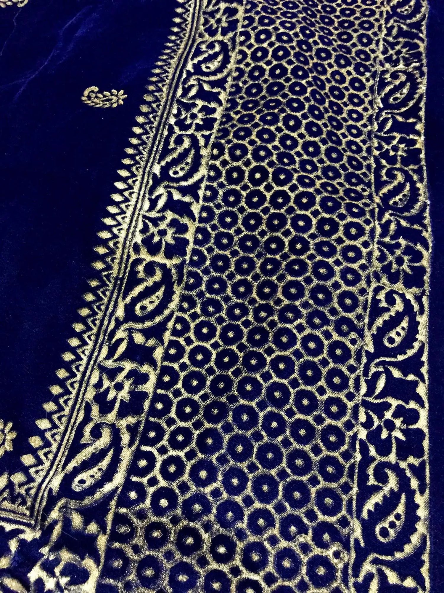 Luxurious velvet shawl detailed with gold block and screen printed designs. Showing a graceful fusion of heritage artistry and elegance.