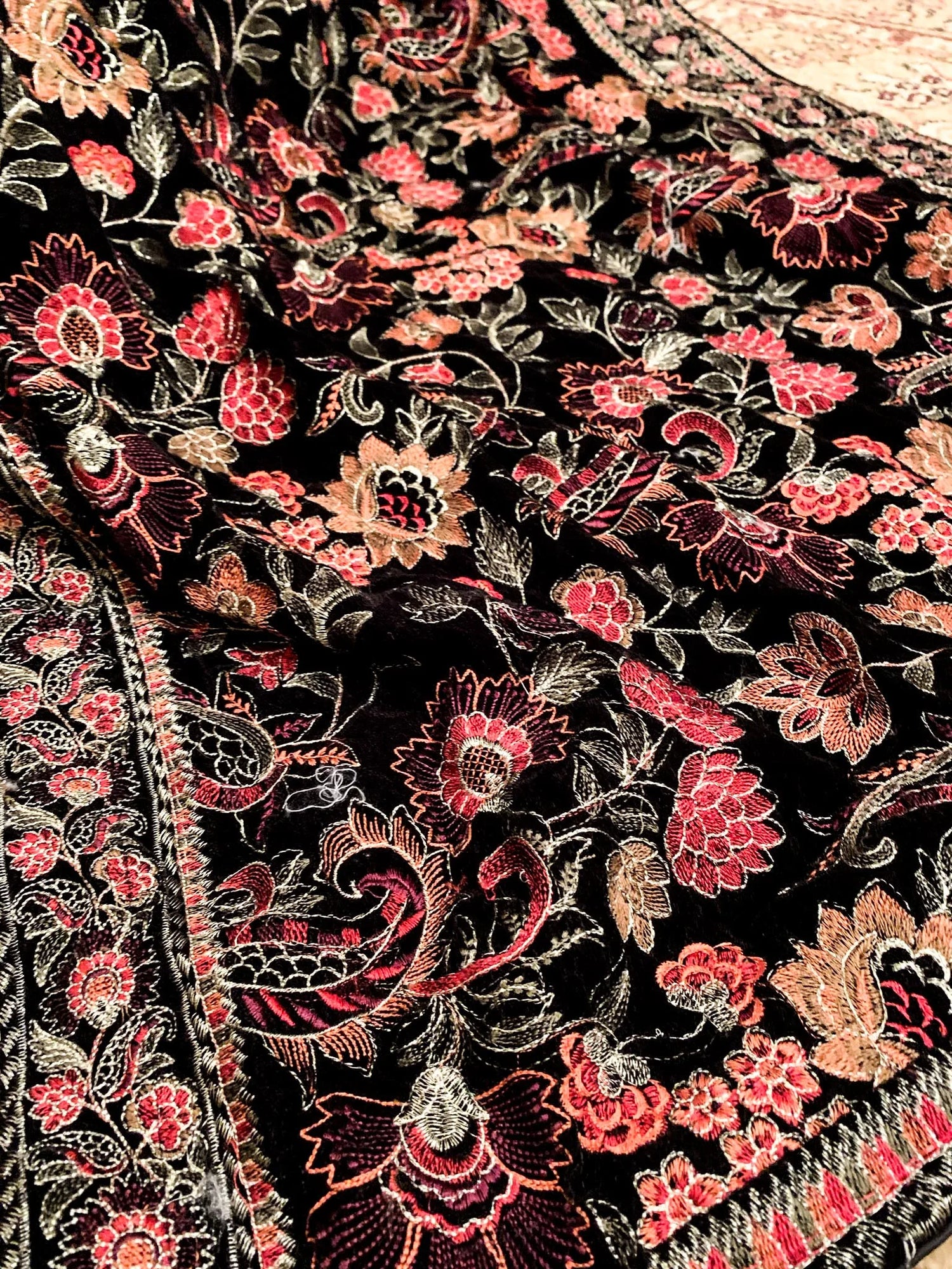 Elegant black and red floral shawl, featuring tila embroidery finished with silk piping, highlighting intricate craftsmanship and luxurious appeal.