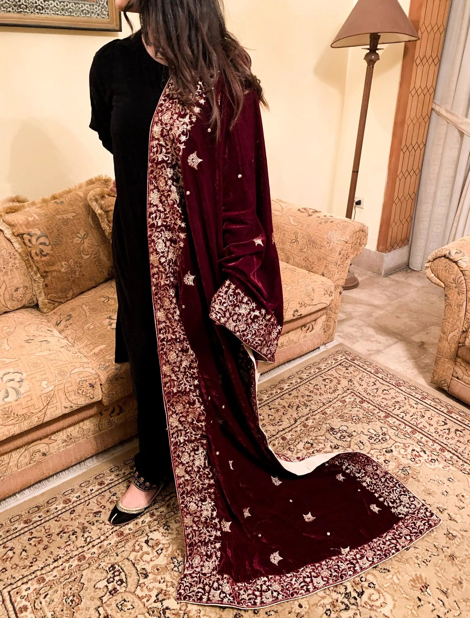 A delicate maroon velvet shawl adorned with exquisite embroidery and a fine boti pattern for elegance.