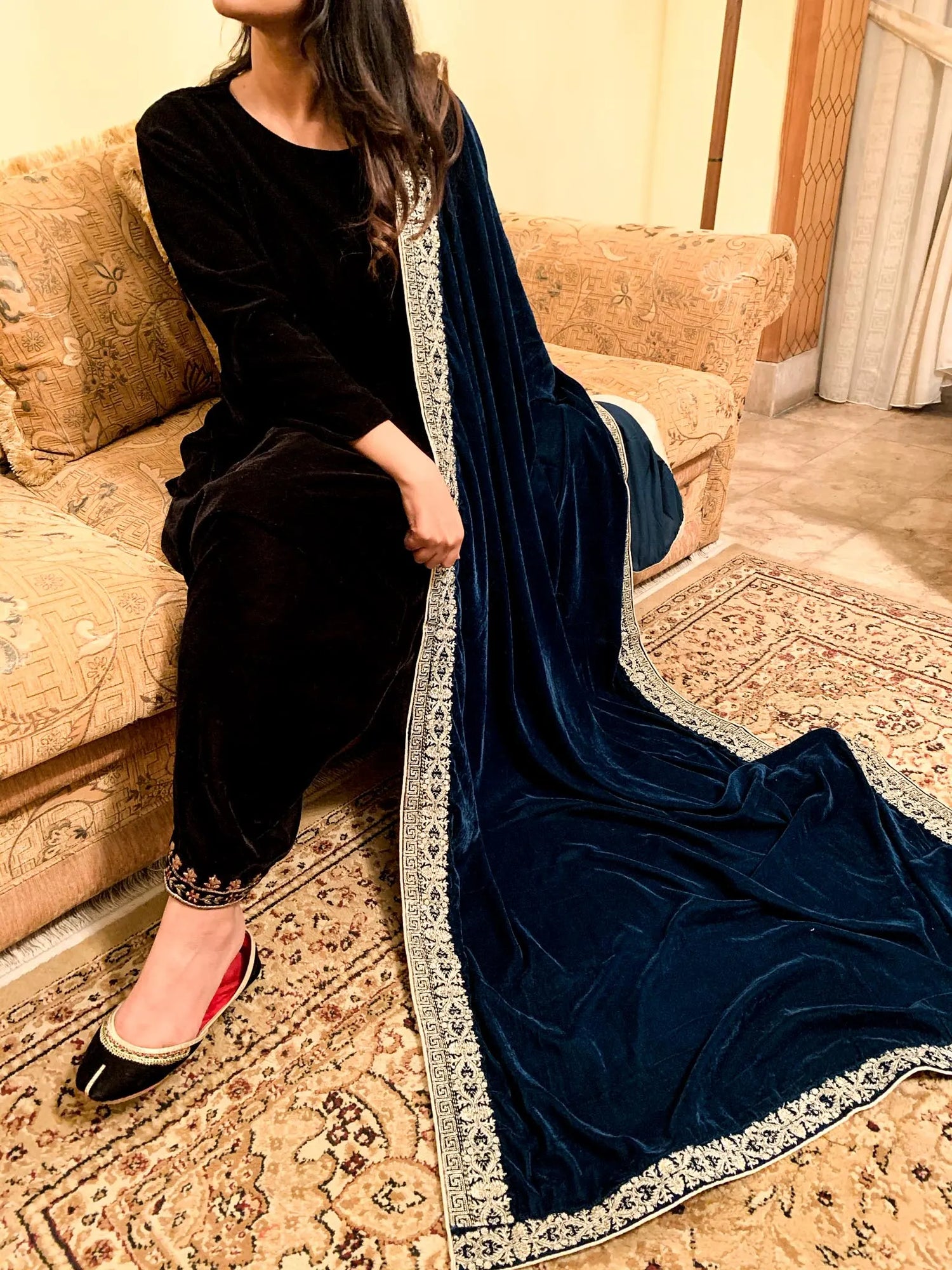 A luxurious velvet shawl featuring detailed geometric tila embroidery, showcasing elegance and sophistication.