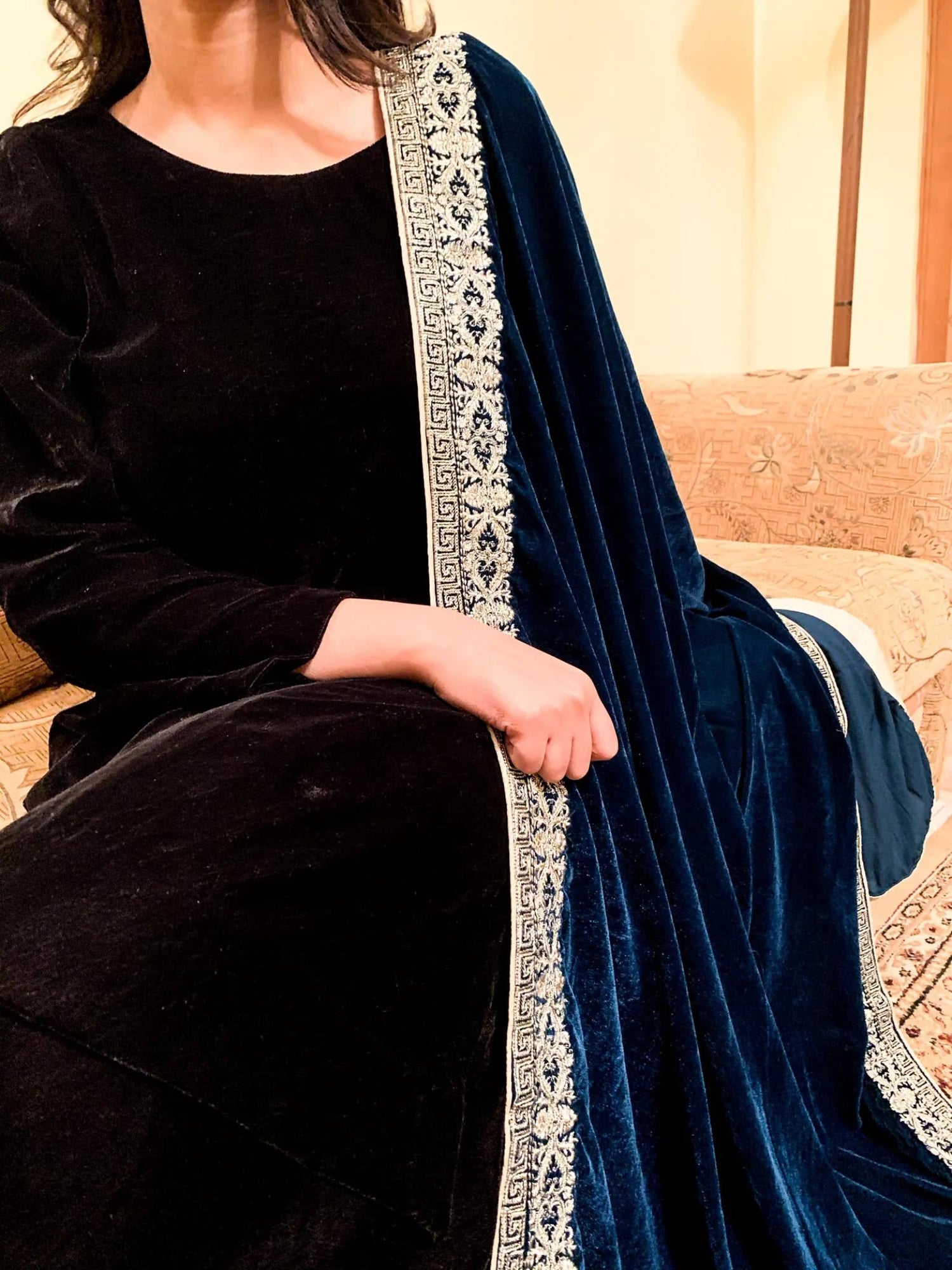 A luxurious velvet shawl featuring detailed geometric tila embroidery, showcasing elegance and sophistication.
