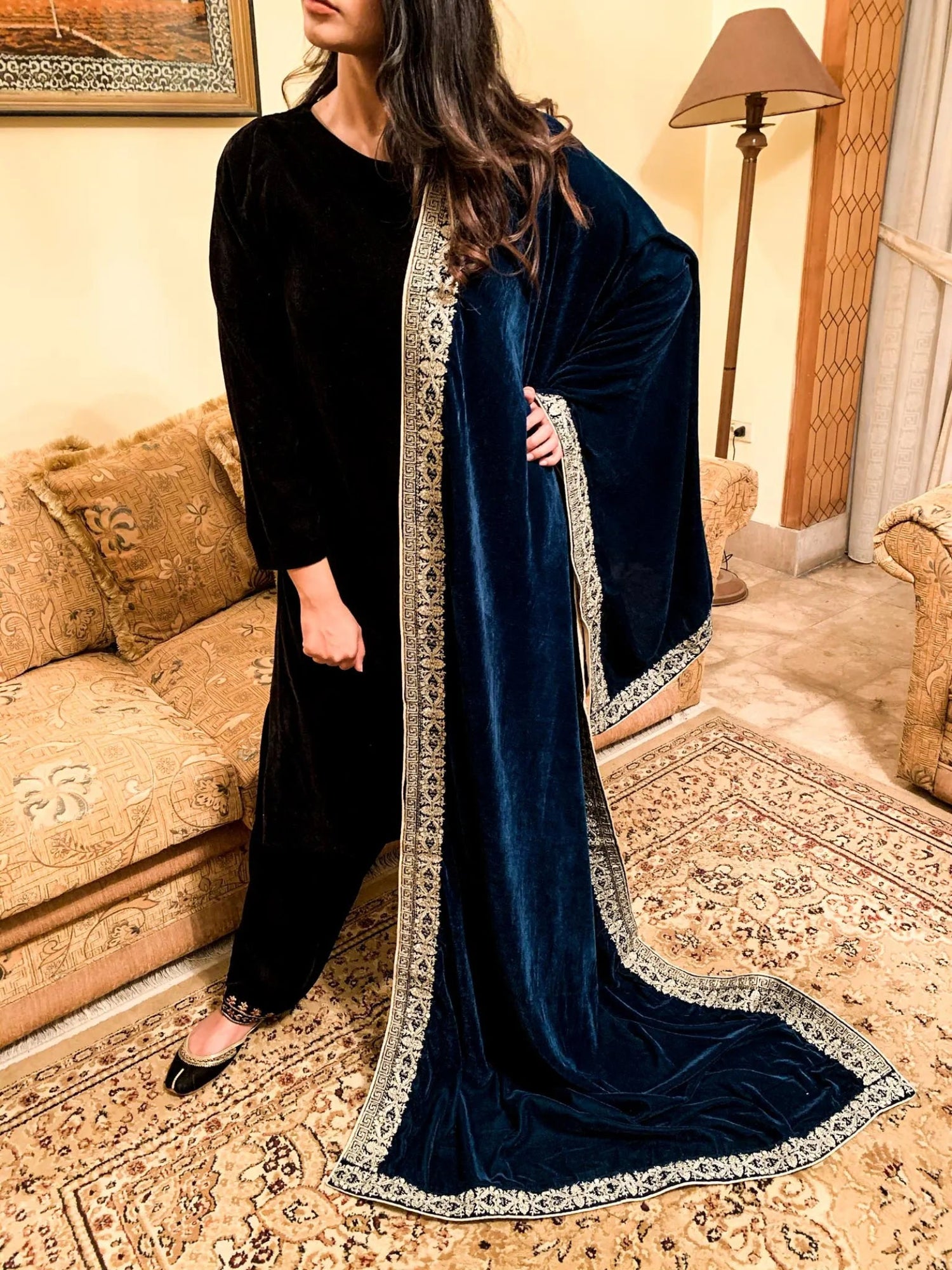 A luxurious velvet shawl featuring detailed geometric tila embroidery, showcasing elegance and sophistication.