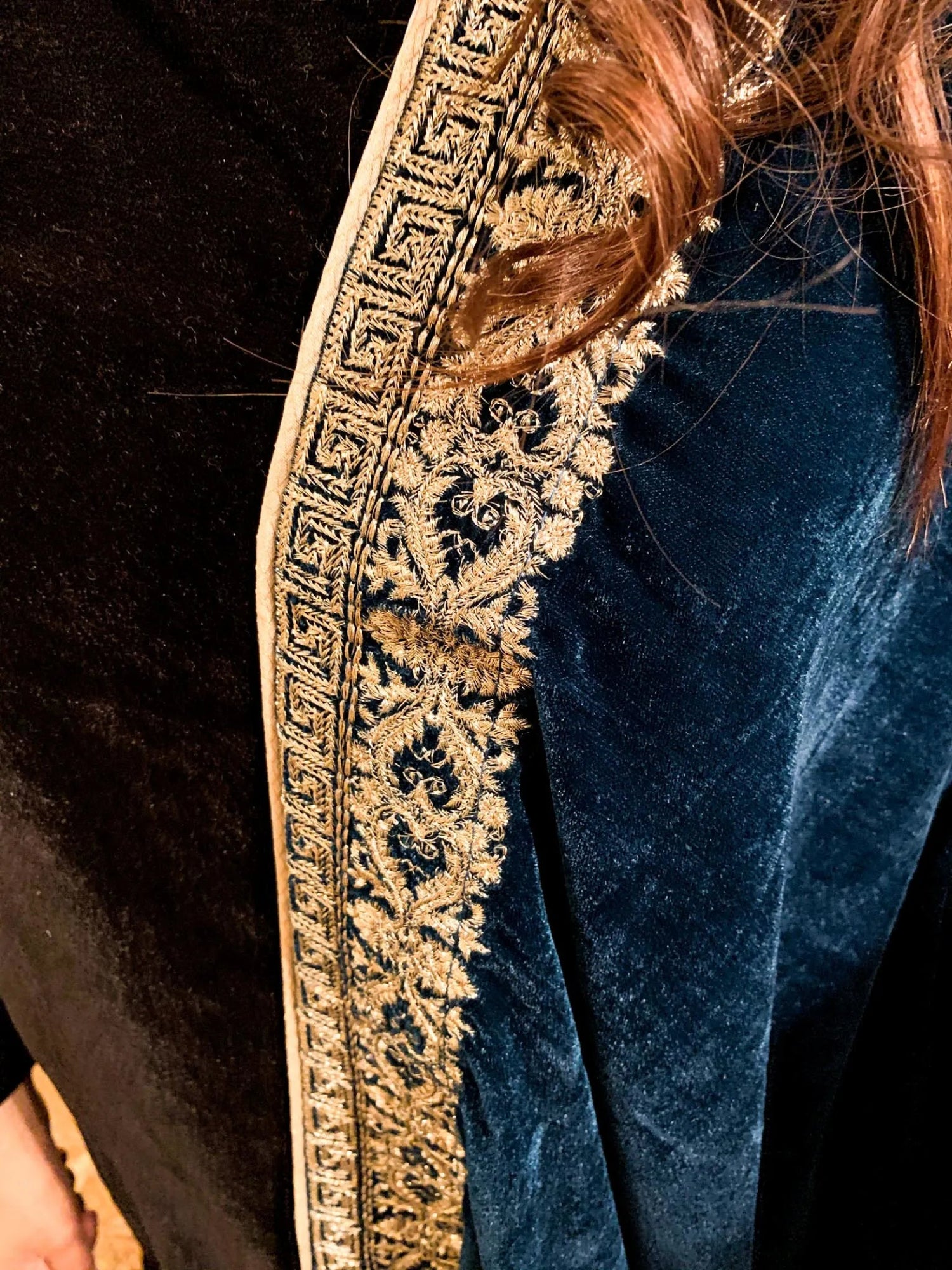 A luxurious velvet shawl featuring detailed geometric tila embroidery, showcasing elegance and sophistication.