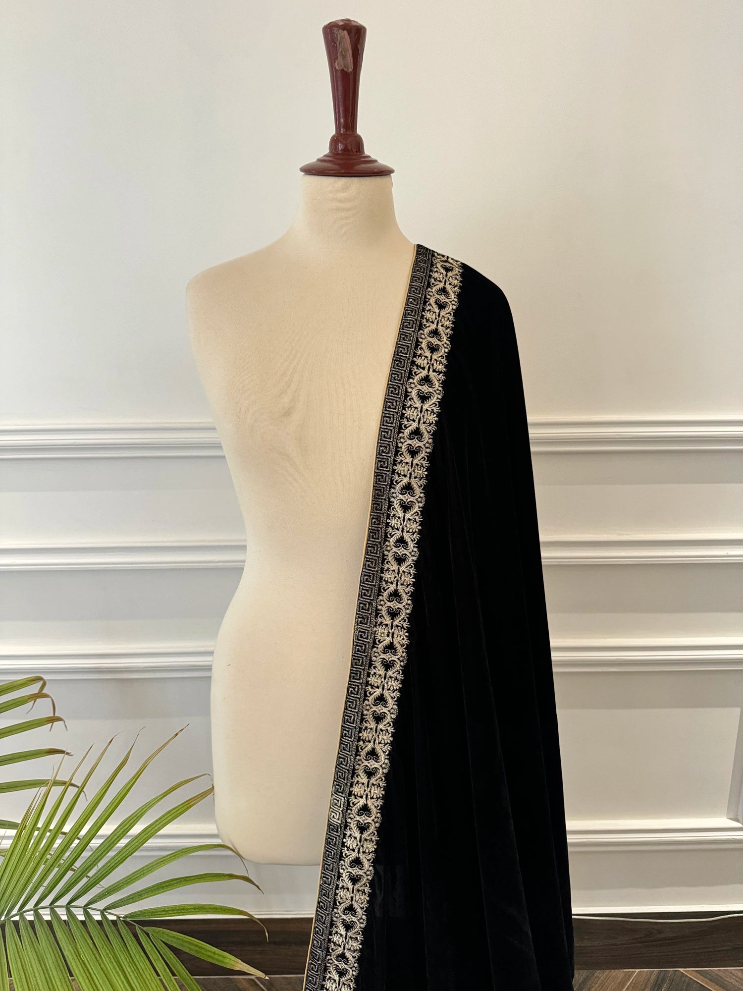 Elegant black velvet shawl featuring detailed tila embroidery on border, perfect for formal events and festive gatherings.