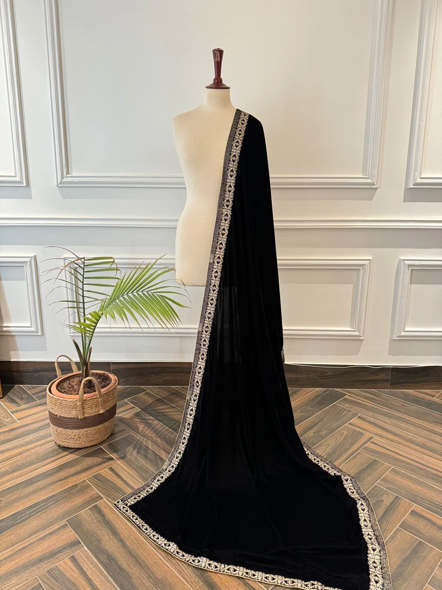 Elegant black velvet shawl featuring detailed tila embroidery on border, perfect for formal events and festive gatherings.