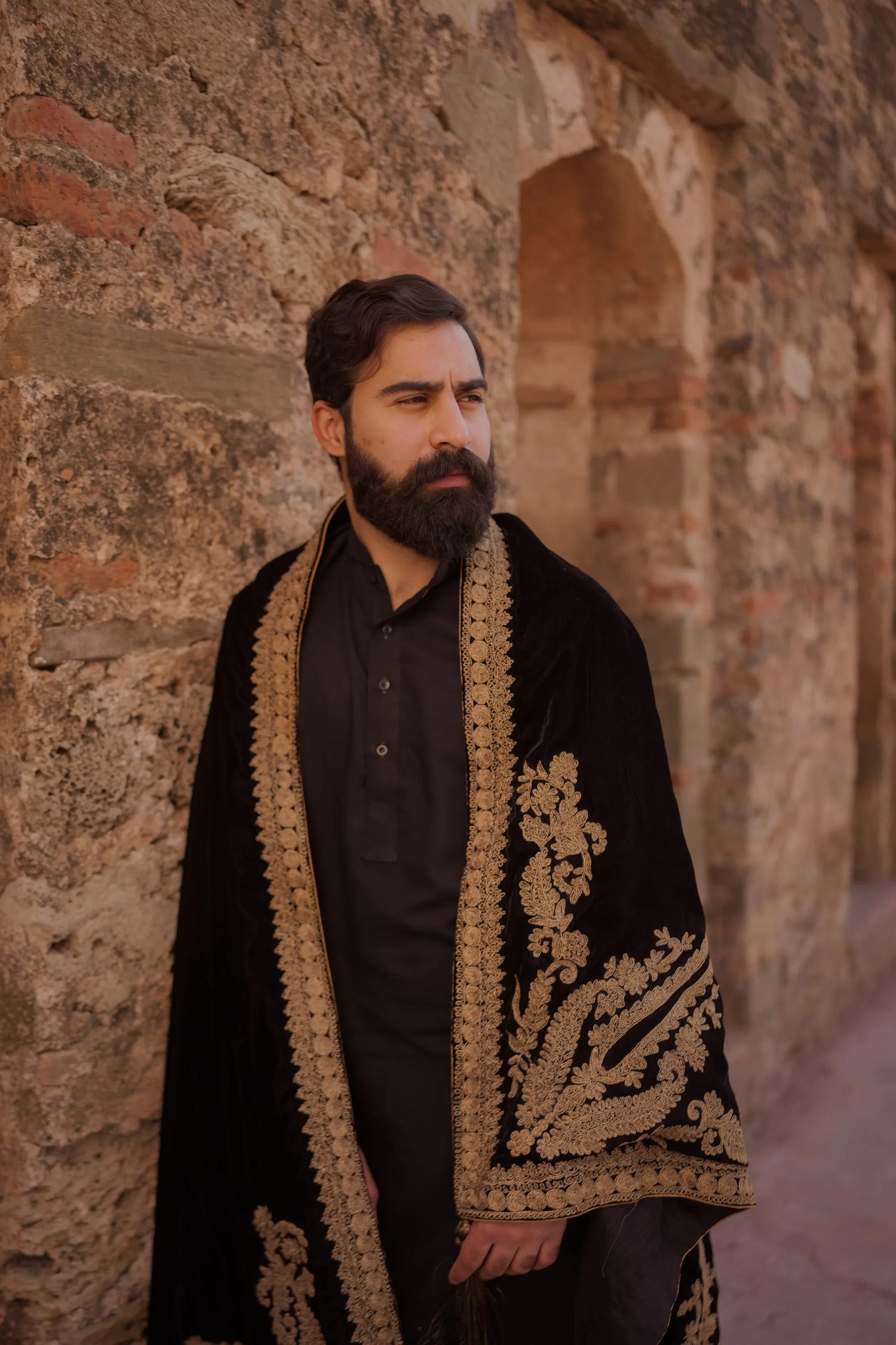 A luxurious black shawl with Ari work, showcasing elegant design details and  festive sophistication.