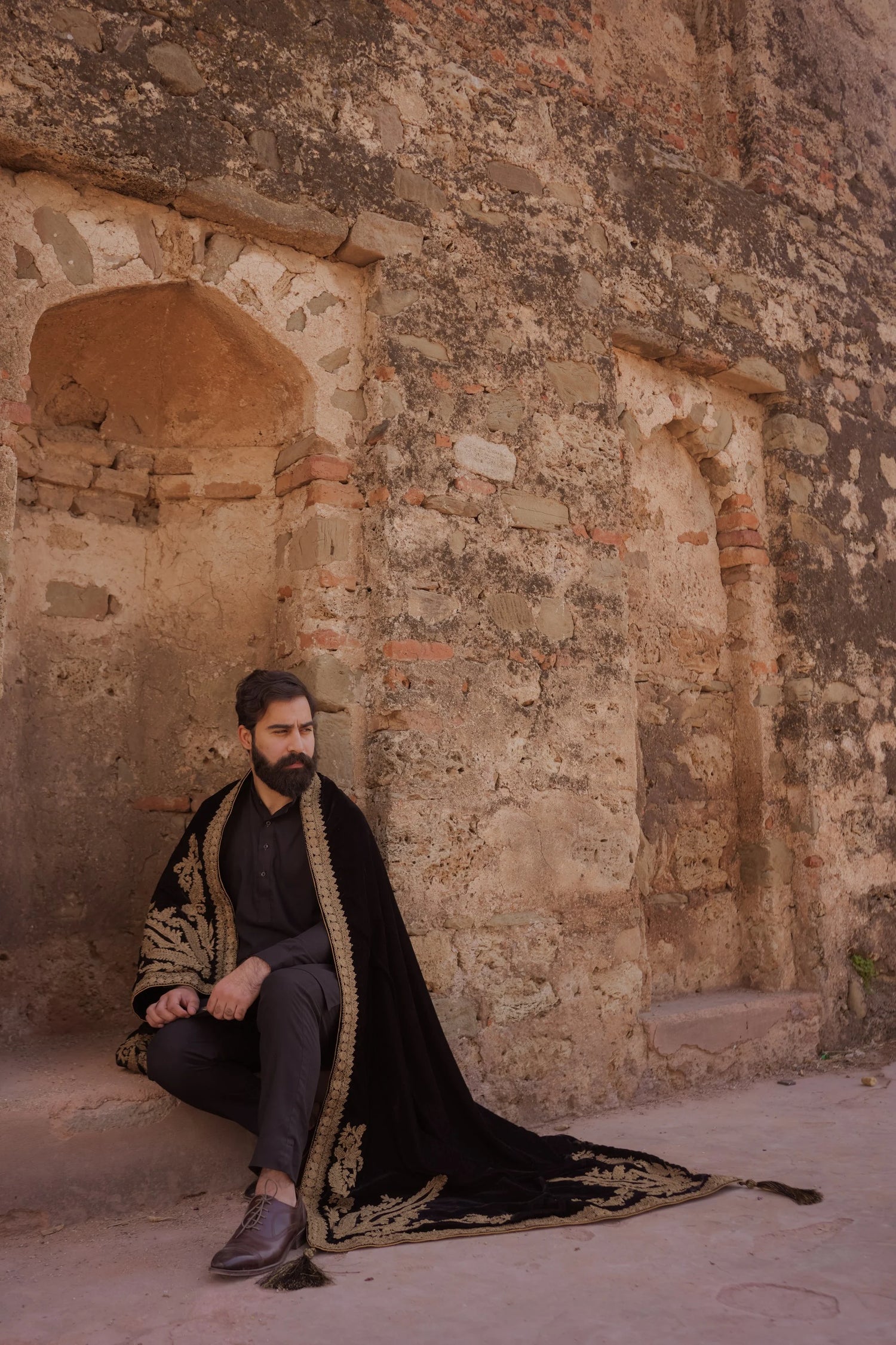A luxurious black shawl with Ari work, showcasing elegant design details and  festive sophistication.