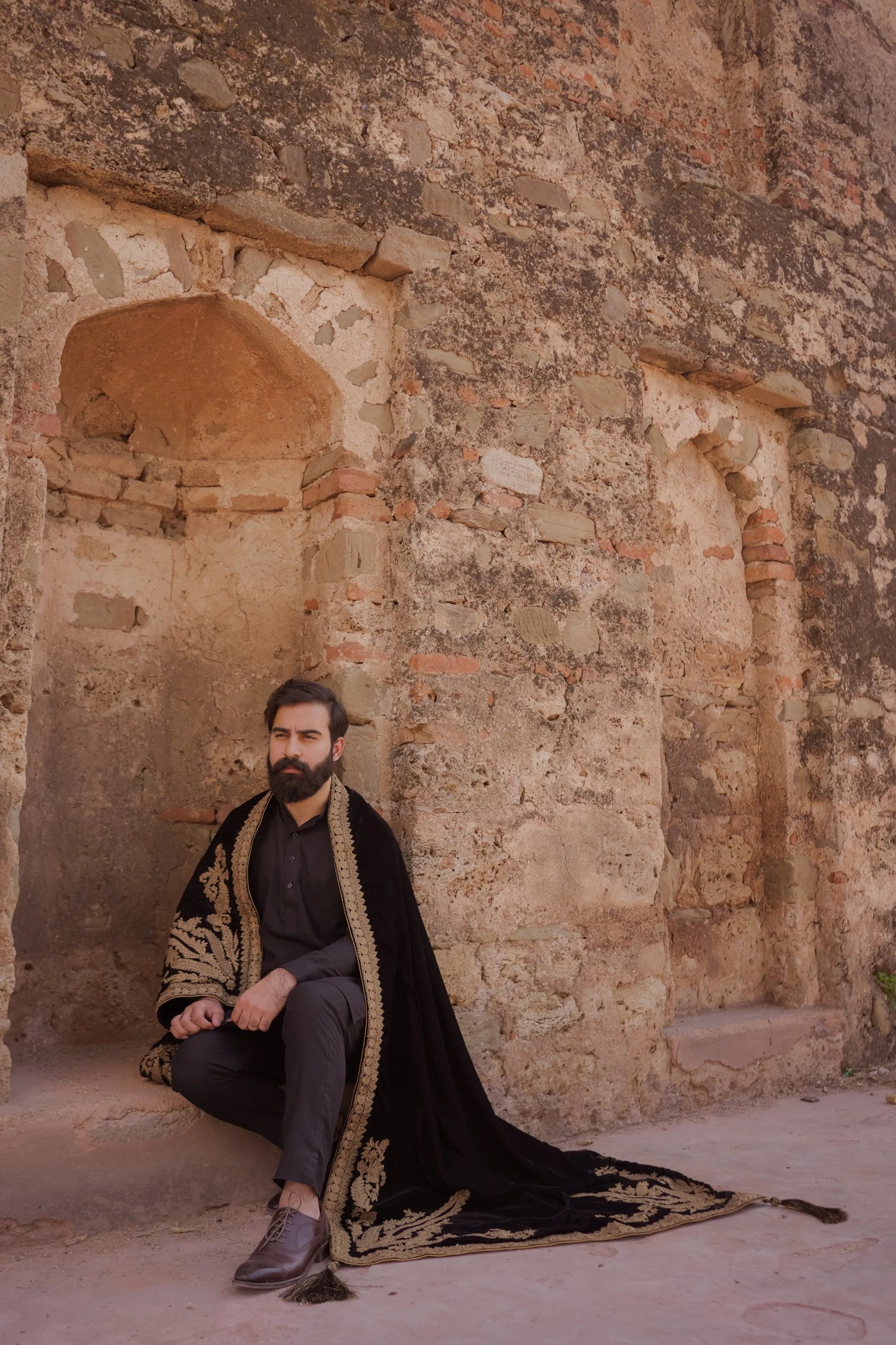 A luxurious black shawl with Ari work, showcasing elegant design details and  festive sophistication.