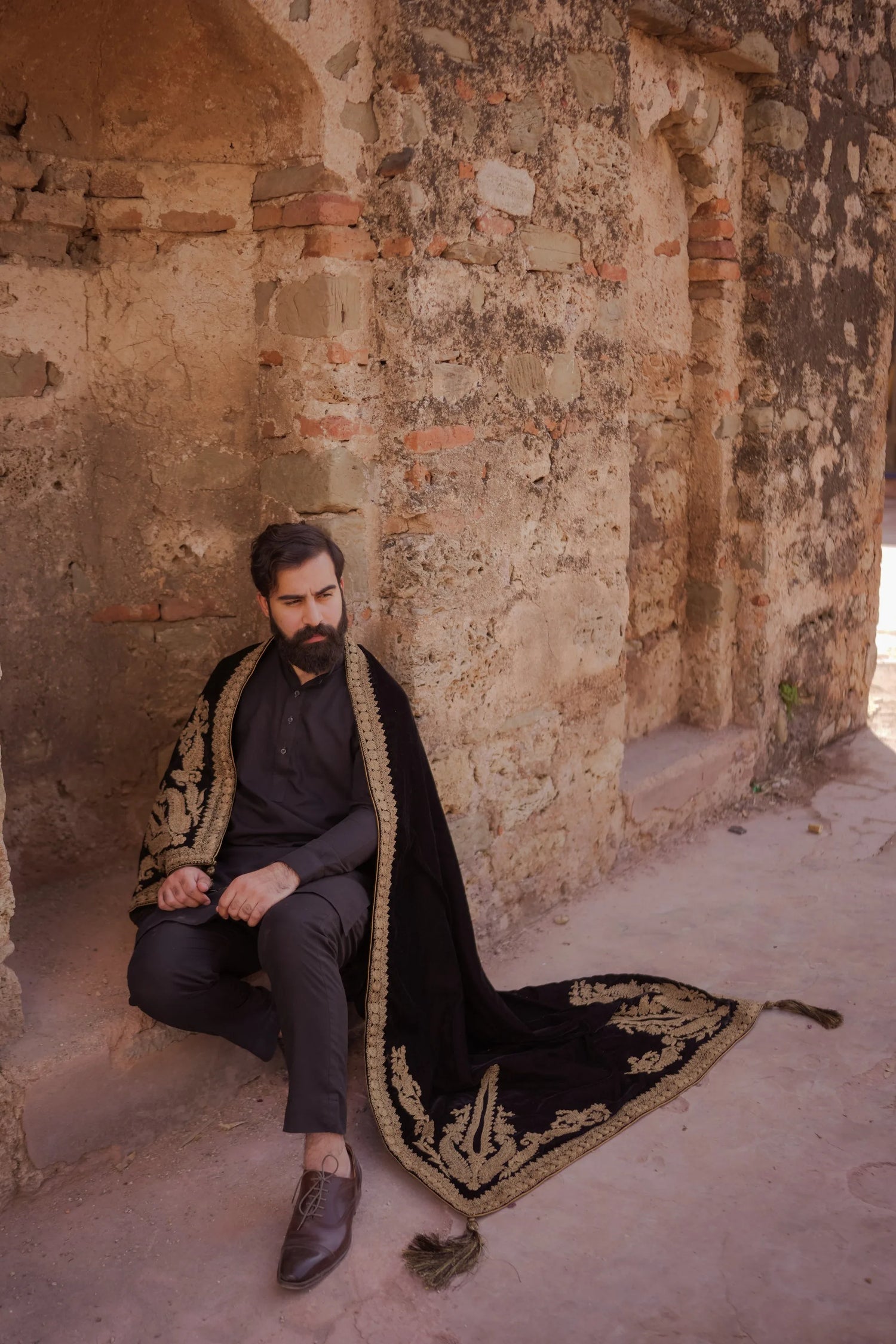 A luxurious black shawl with Ari work, showcasing elegant design details and  festive sophistication.