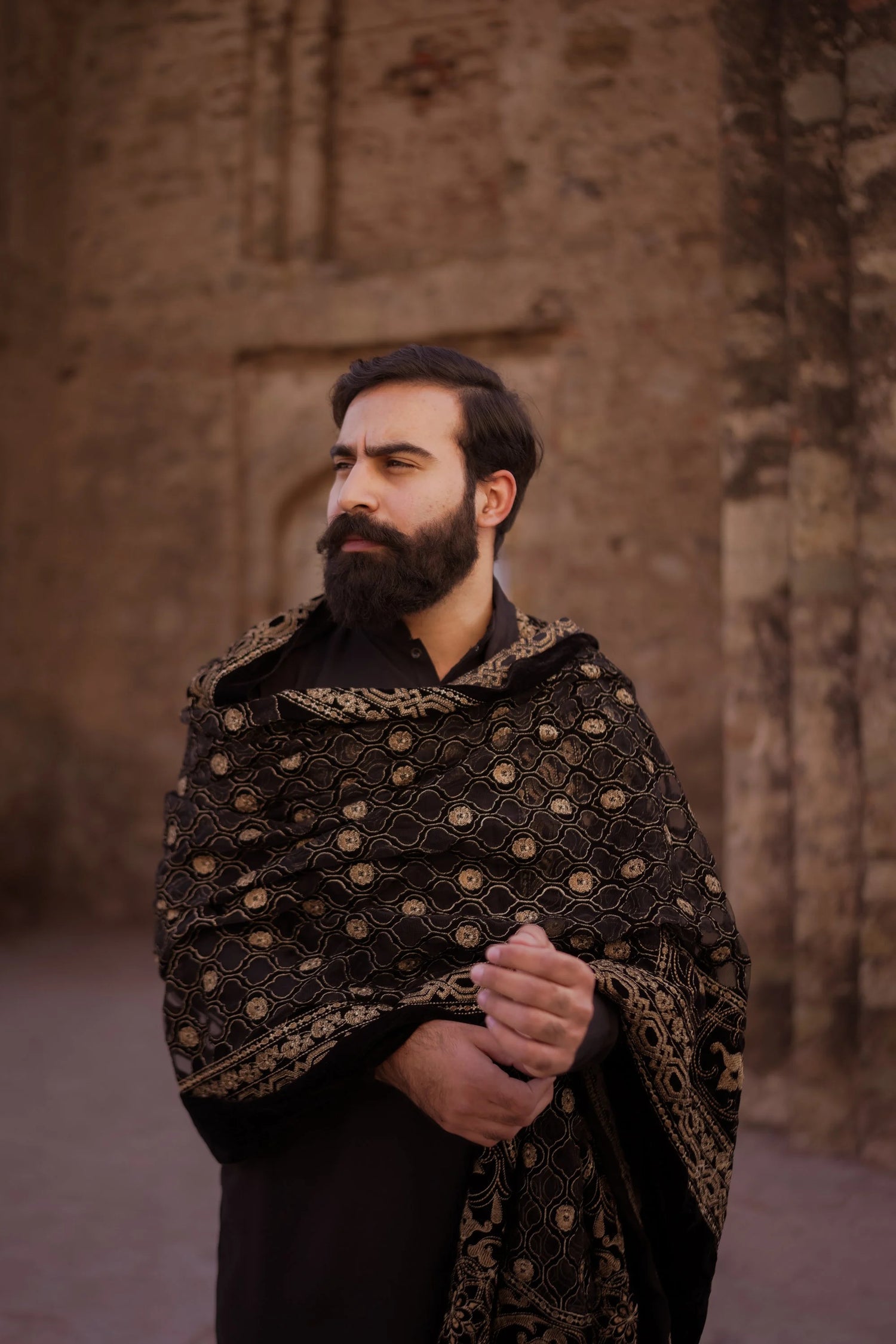 Luxurious black velvet shawl adored with detailed cut work and laser embroidery, perfect for formal and festive wear.