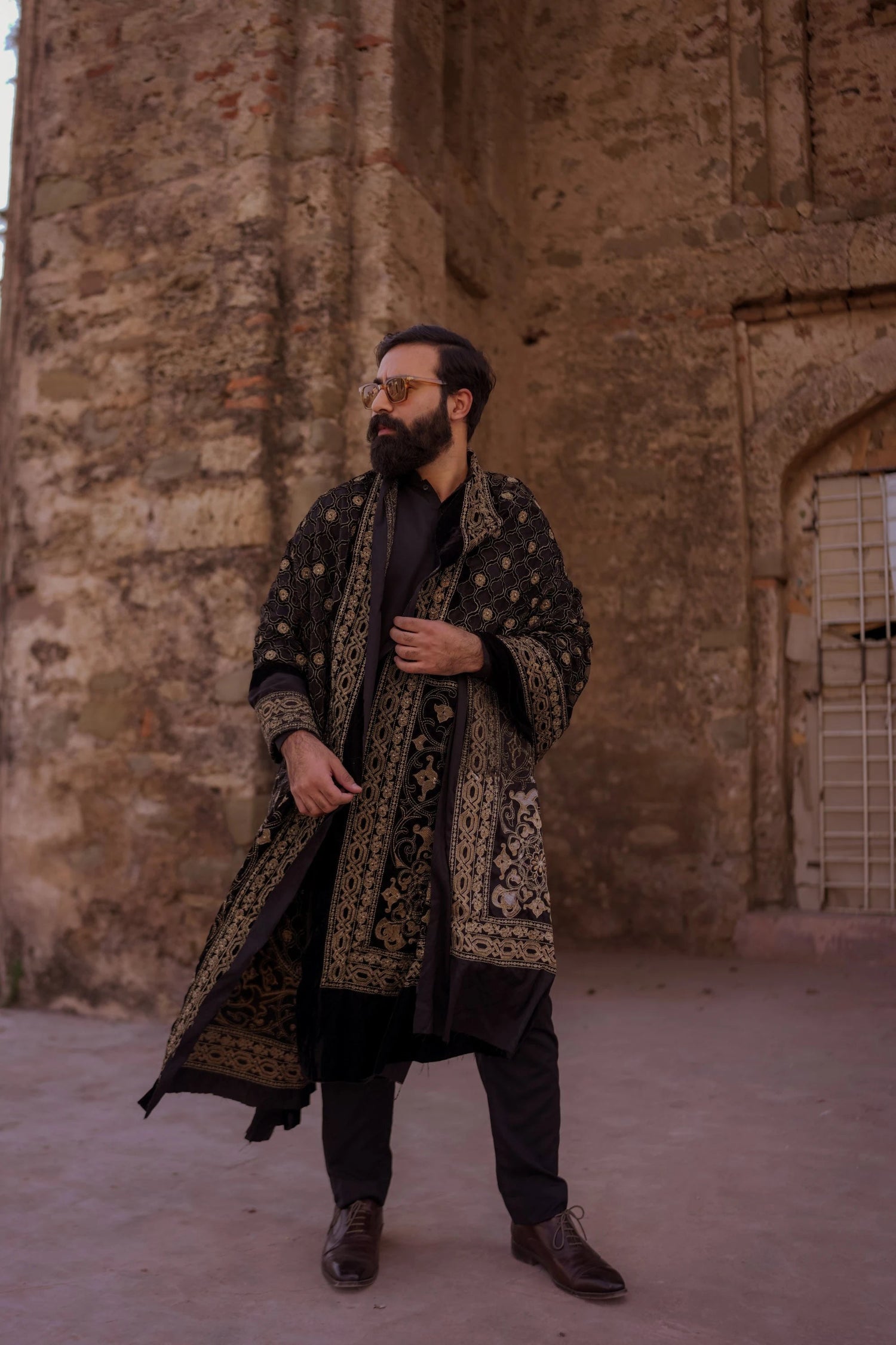 Luxurious black velvet shawl adored with detailed cut work and laser embroidery, perfect for formal and festive wear.