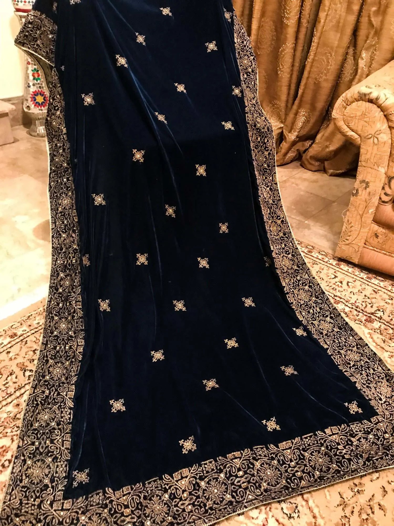 Beautifully crafted velvet shawl featuring intricate gold tila embroidery complemented with chata work and a Banarsi border exuding sophistication, perfect for formal events.