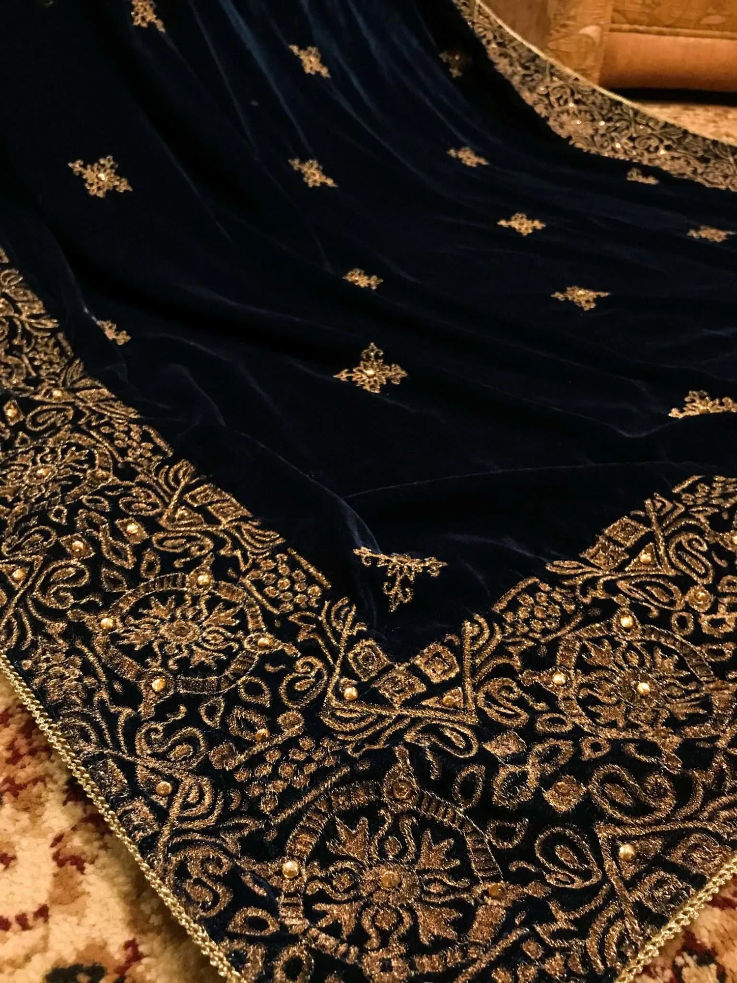 Beautifully crafted velvet shawl featuring intricate gold tila embroidery complemented with chata work and a Banarsi border exuding sophistication, perfect for formal events.