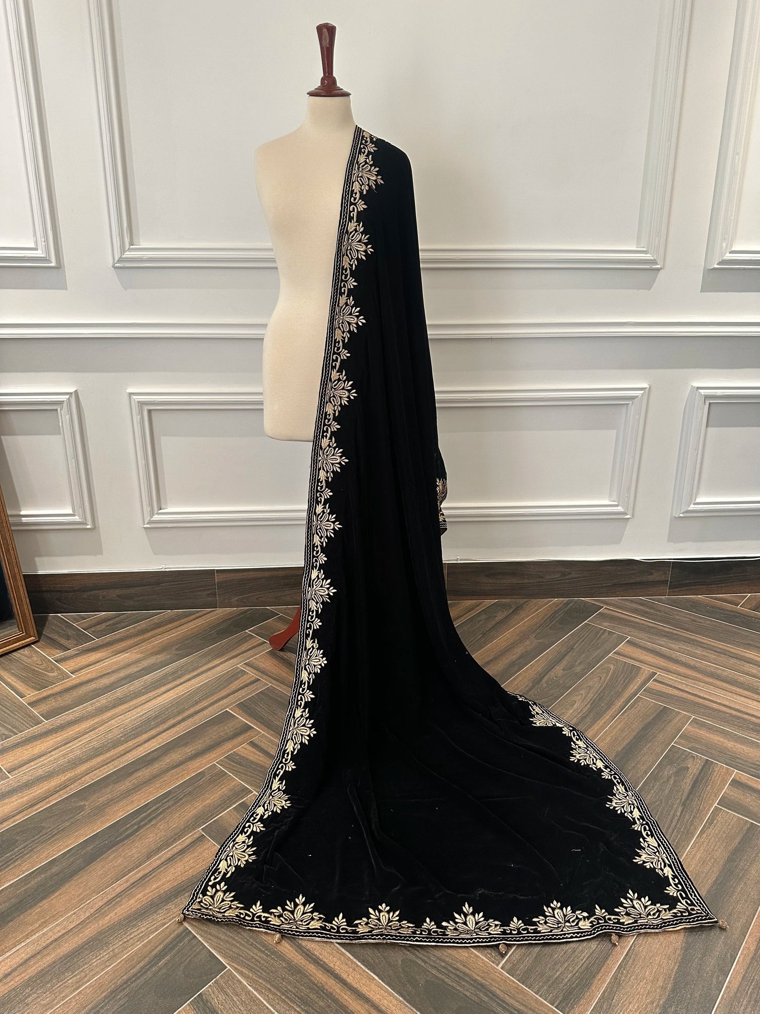 Elevate your style with Royal Luxe unisex velvet shawl with fine golden thread embroidery on four sides, featuring Jamawar palta lining on the back of borders, ideal for weddings and festive occasions.