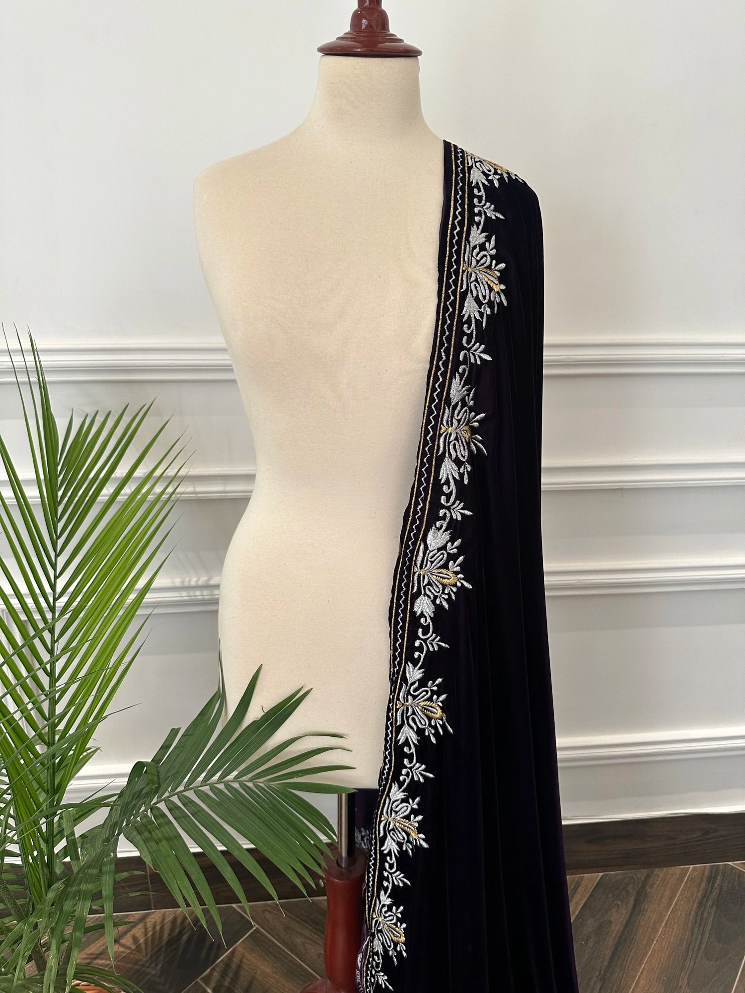 Elevate your style with Royal Luxe unisex velvet shawl with fine golden thread embroidery on four sides, featuring Jamawar palta lining on the back of borders, ideal for weddings and festive occasions.