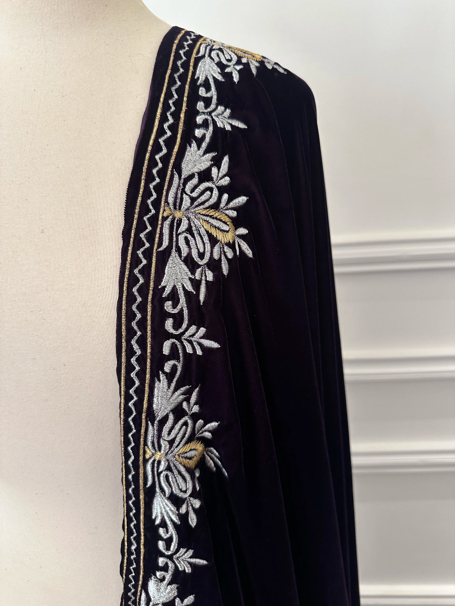 Elevate your style with Royal Luxe unisex velvet shawl with fine golden thread embroidery on four sides, featuring Jamawar palta lining on the back of borders, ideal for weddings and festive occasions.