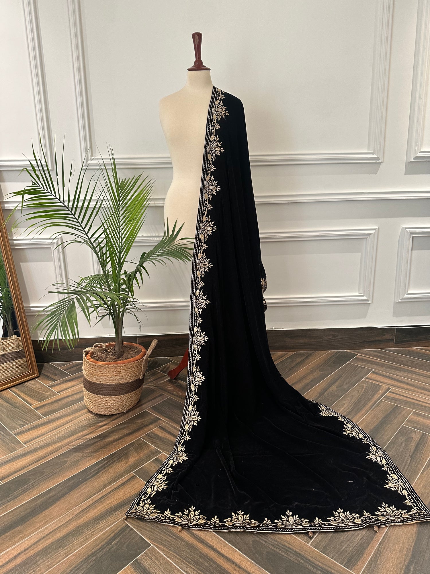 Elevate your style with Royal Luxe unisex velvet shawl with fine golden thread embroidery on four sides, featuring Jamawar palta lining on the back of borders, ideal for weddings and festive occasions.