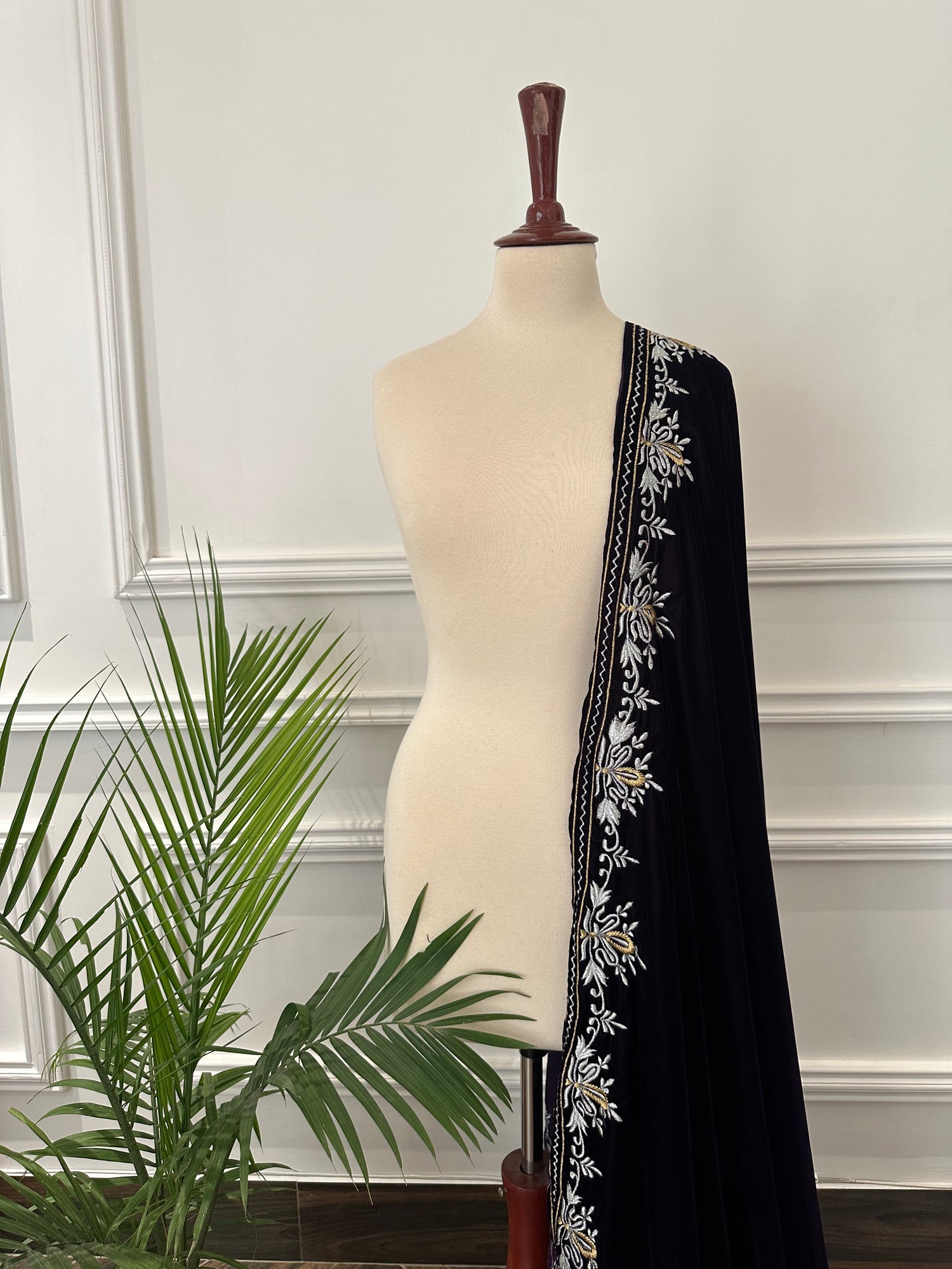Elevate your style with Royal Luxe unisex velvet shawl with fine golden thread embroidery on four sides, featuring Jamawar palta lining on the back of borders, ideal for weddings and festive occasions.