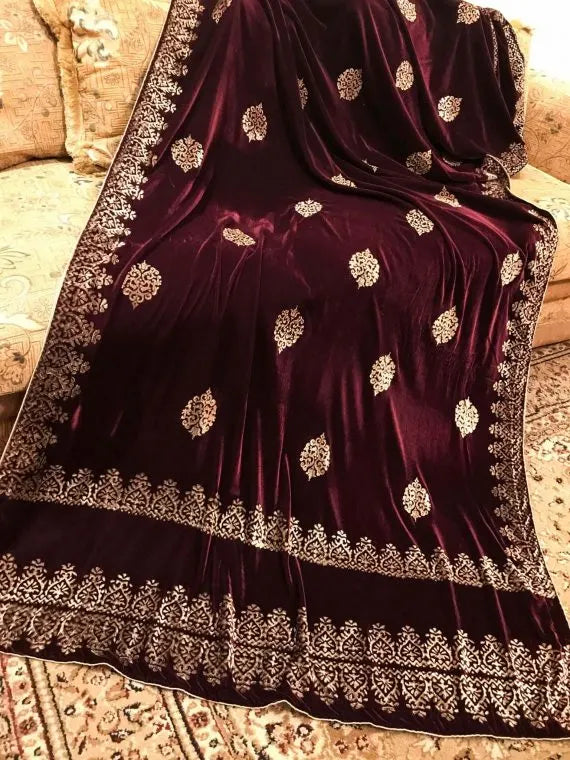 Elegant velvet shawl with gold embroidery, featuring intricate motifs and tassels, perfect for elegant occasions.