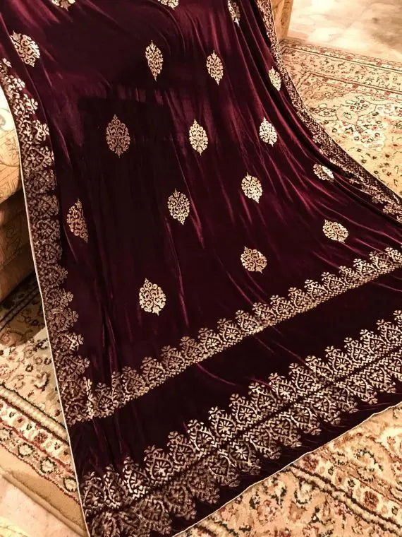 Elegant velvet shawl with gold embroidery, featuring intricate motifs and tassels, perfect for elegant occasions.