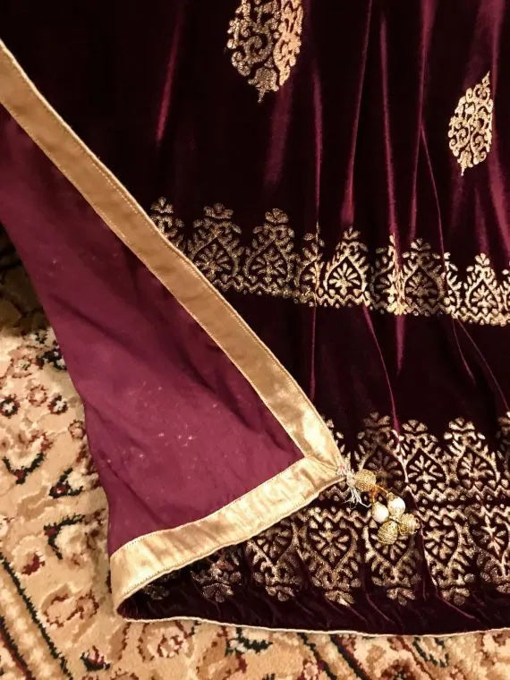 Elegant velvet shawl with gold embroidery, featuring intricate motifs and tassels, perfect for elegant occasions.