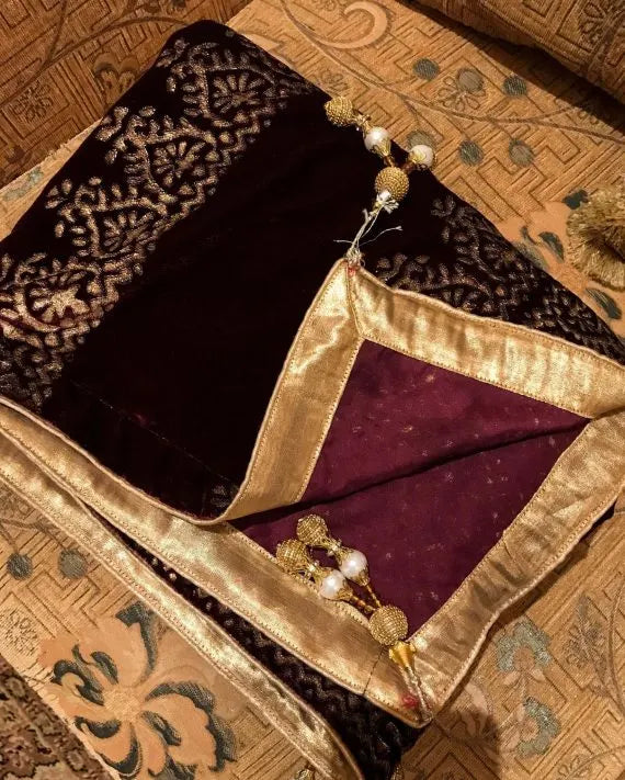 Elegant velvet shawl with gold embroidery, featuring intricate motifs and tassels, perfect for elegant occasions.