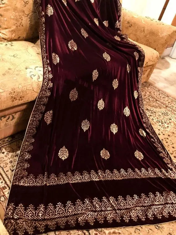 Elegant velvet shawl with gold embroidery, featuring intricate motifs and tassels, perfect for elegant occasions.