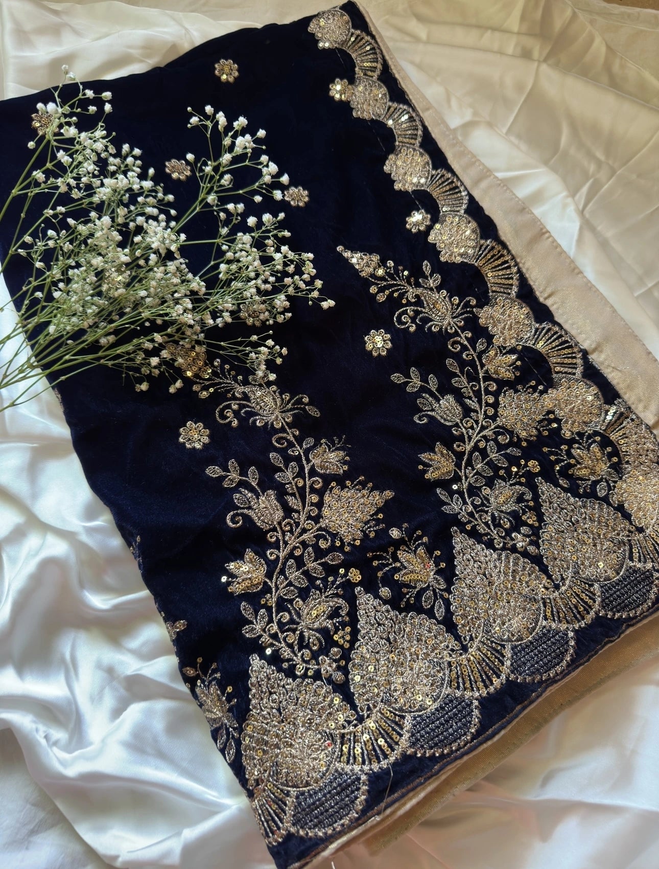 Luxurious velvet shawl featuring detailed embroidery and beautiful crafted motifs, blending traditional artistry with modern elegance for any occasion.