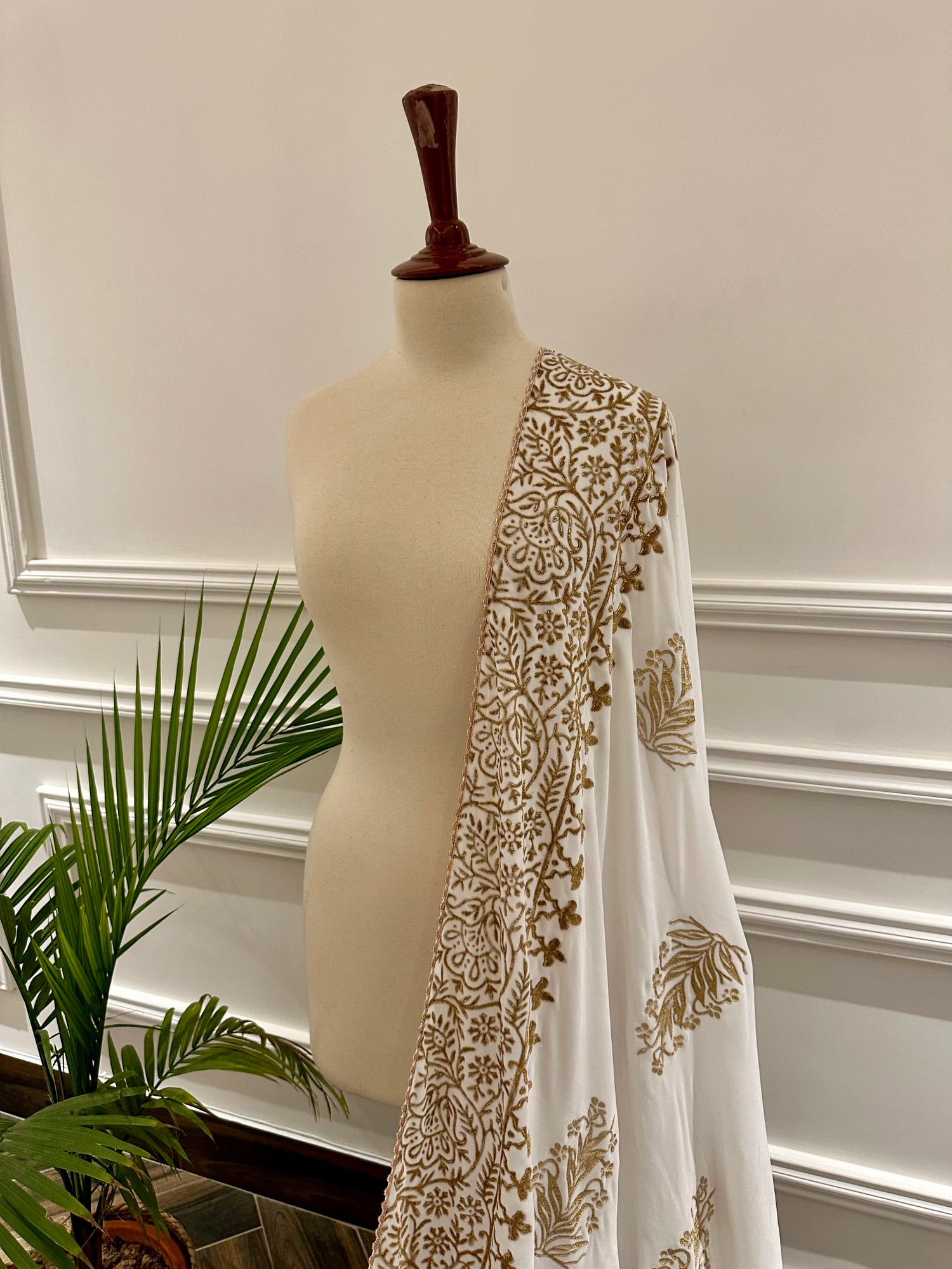 White and gold embroidered velvet shawl featuring a luxurious gold block printed border, showcasing intricate craftsmanship and elegant design.