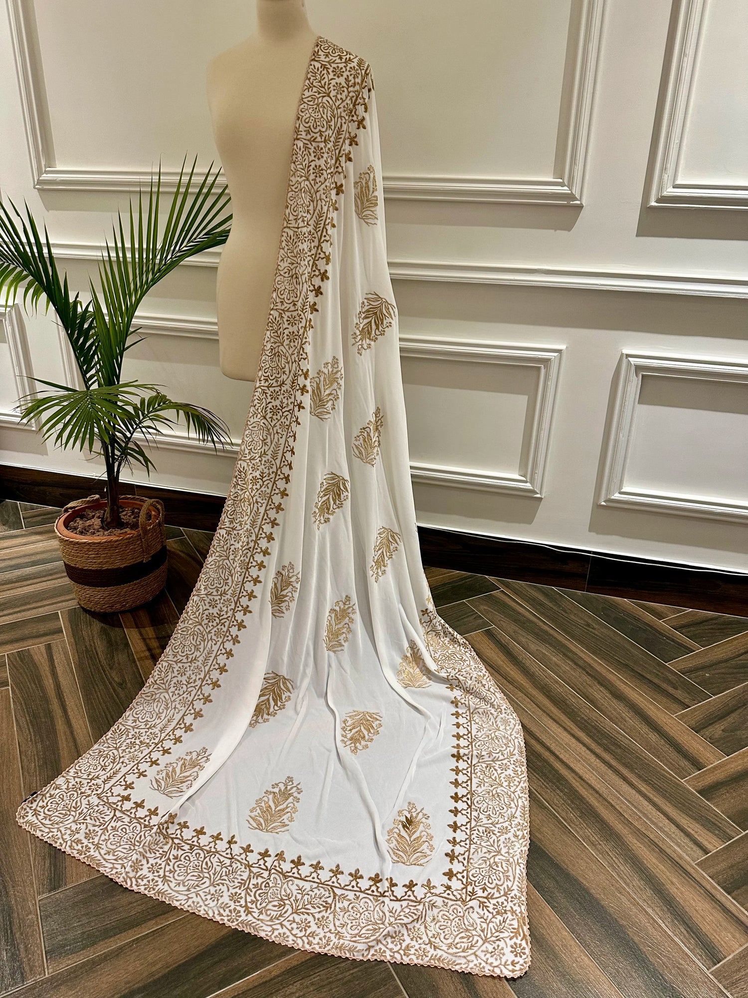 White and gold embroidered velvet shawl featuring a luxurious gold block printed border, showcasing intricate craftsmanship and elegant design.