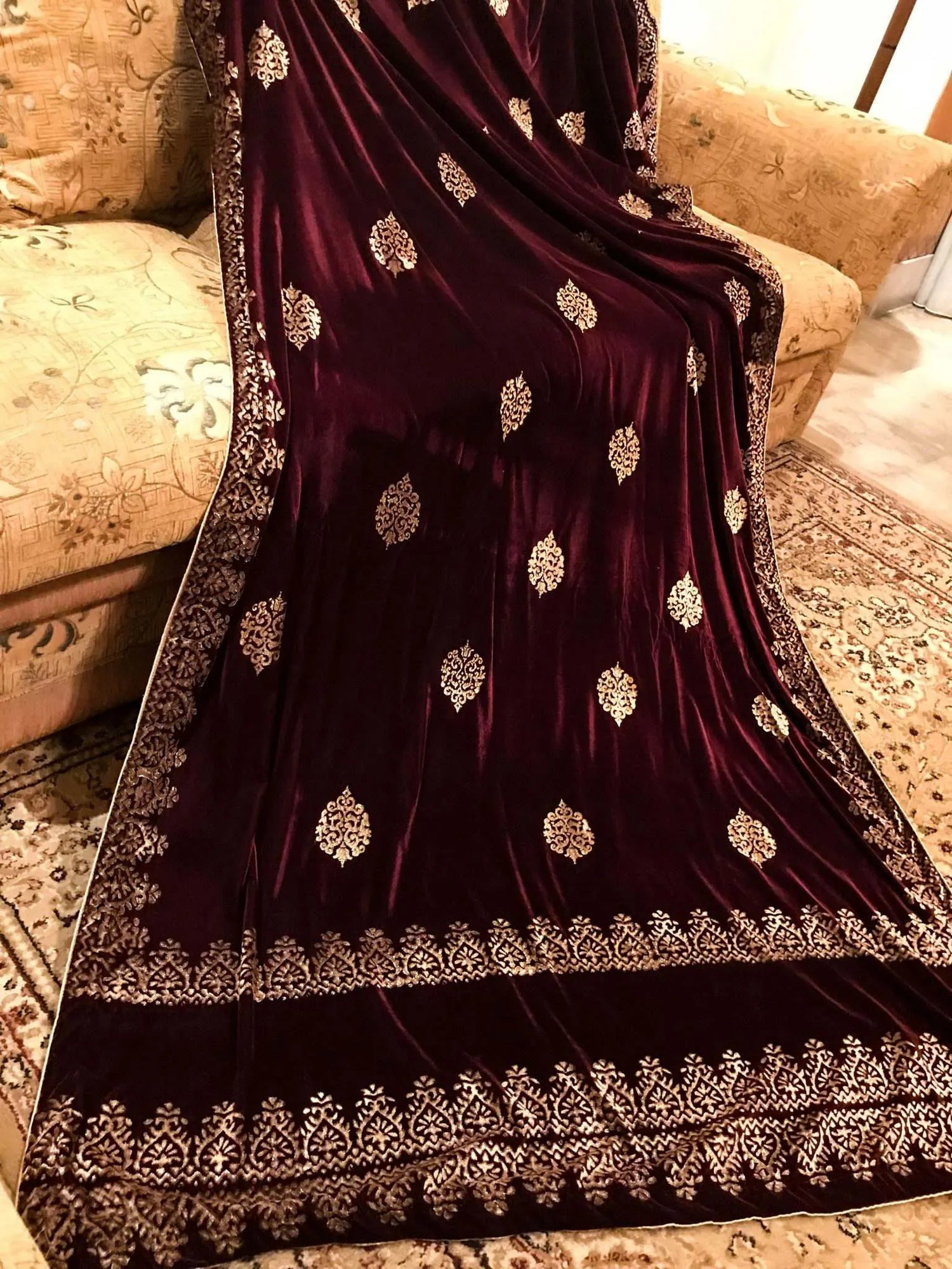 Elegant velvet shawl showcasing screen-printed motifs with block-printed double border. Ideal for festive occasions and weddings.