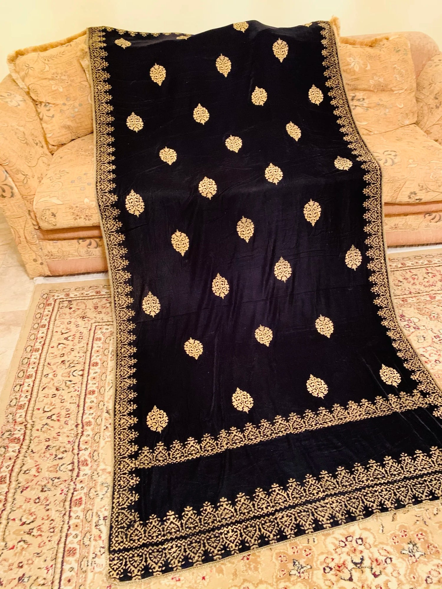 Elegant velvet shawl showcasing screen-printed motifs with block-printed double border. Ideal for festive occasions and weddings.