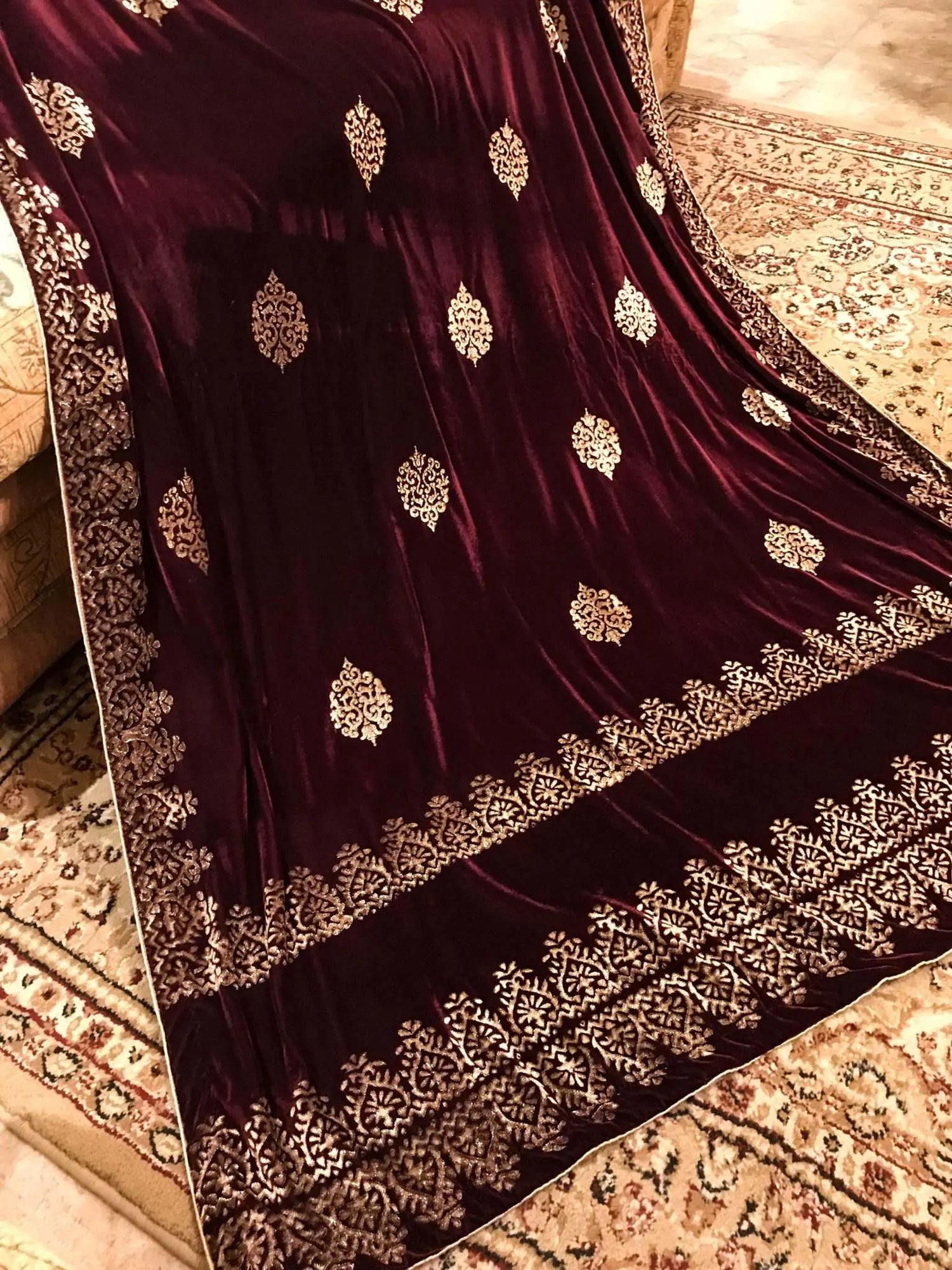 Elegant velvet shawl showcasing screen-printed motifs with block-printed double border. Ideal for festive occasions and weddings.