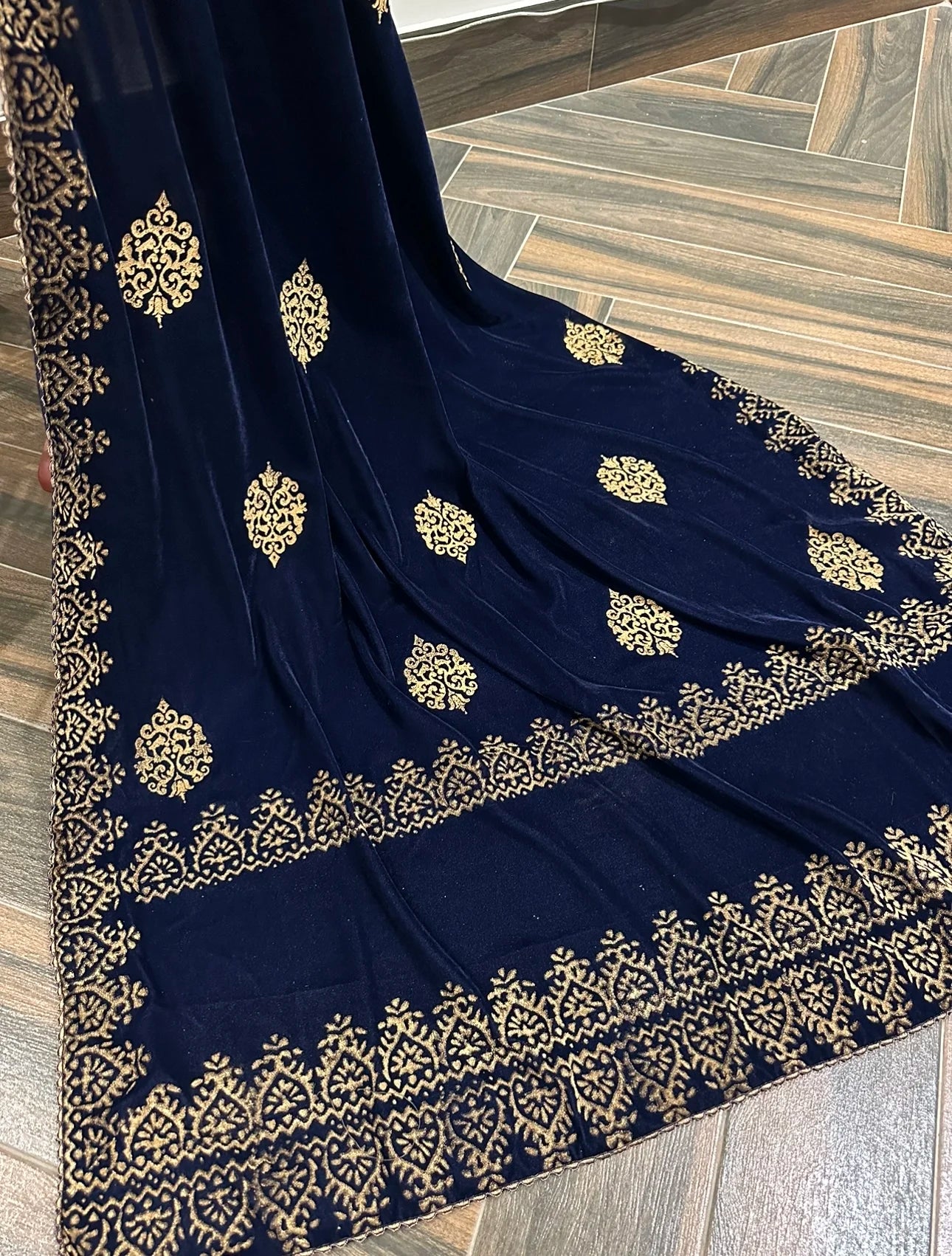 Elegant velvet shawl showcasing screen-printed motifs with block-printed double border. Ideal for festive occasions and weddings.