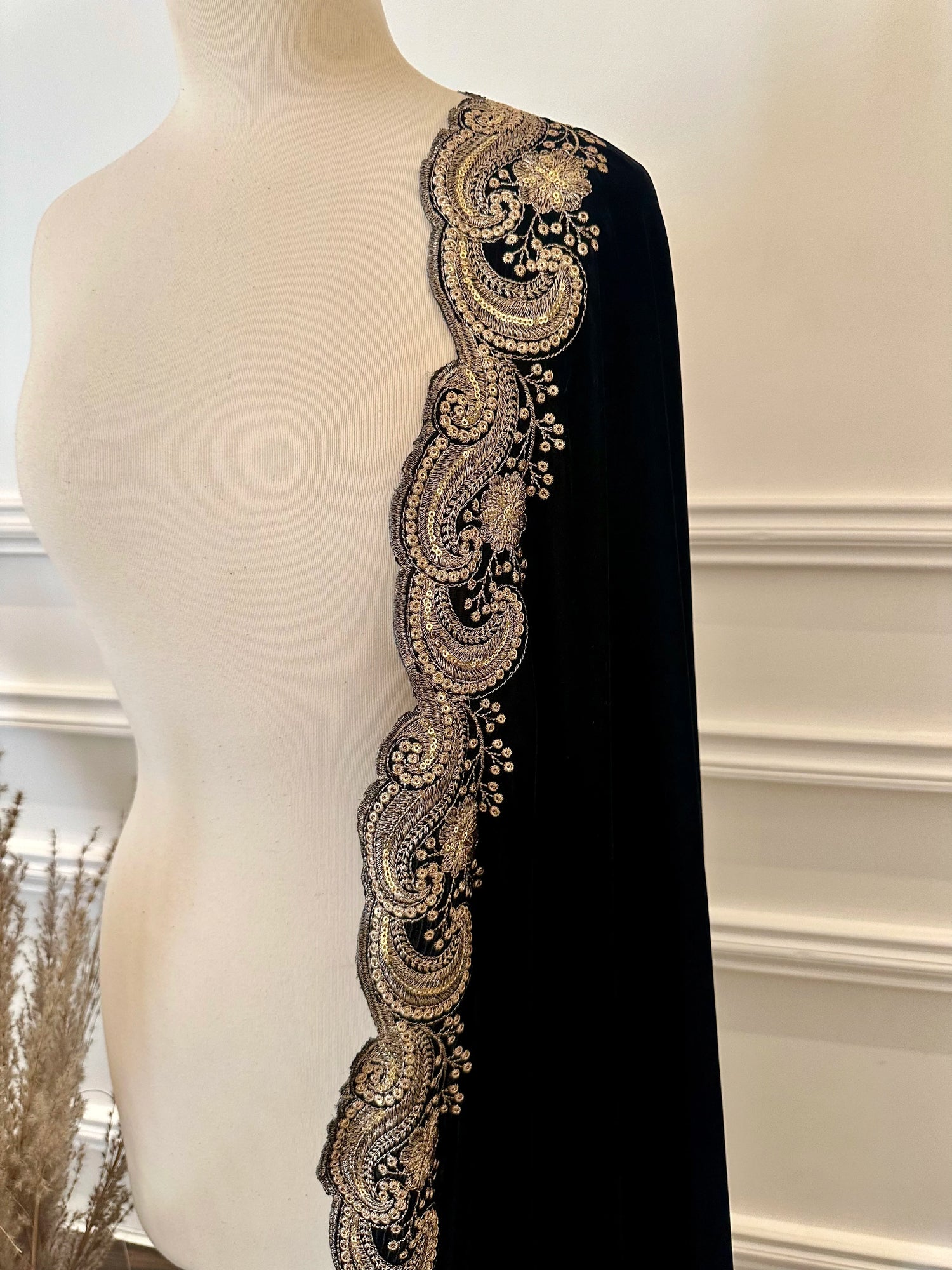 Velvet shawl featuring intricate embellishments and a combination of shimmering tila, sparkling sequins, and delicate stone work. Showcasing exquisite craftsmanship and rich texture, perfect for formal occasions.
