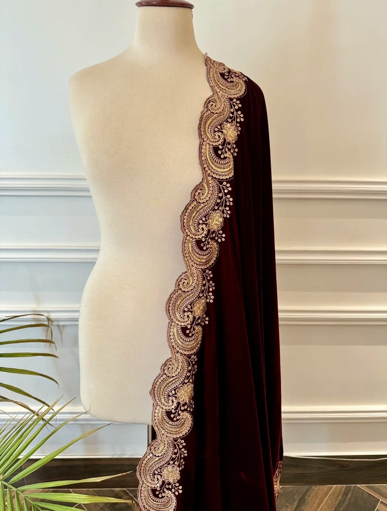 Velvet shawl featuring intricate embellishments and a combination of shimmering tila, sparkling sequins, and delicate stone work. Showcasing exquisite craftsmanship and rich texture, perfect for formal occasions.