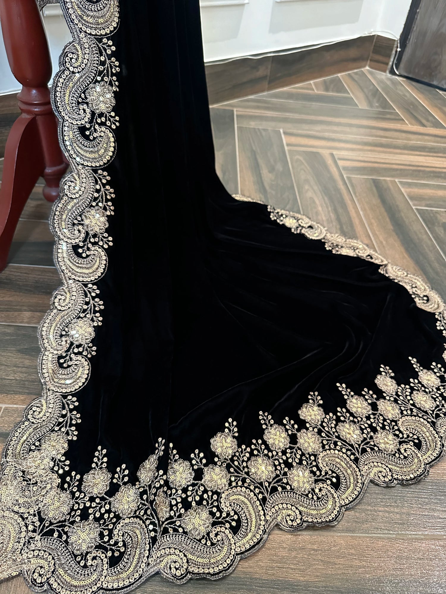 Velvet shawl featuring intricate embellishments and a combination of shimmering tila, sparkling sequins, and delicate stone work. Showcasing exquisite craftsmanship and rich texture, perfect for formal occasions.