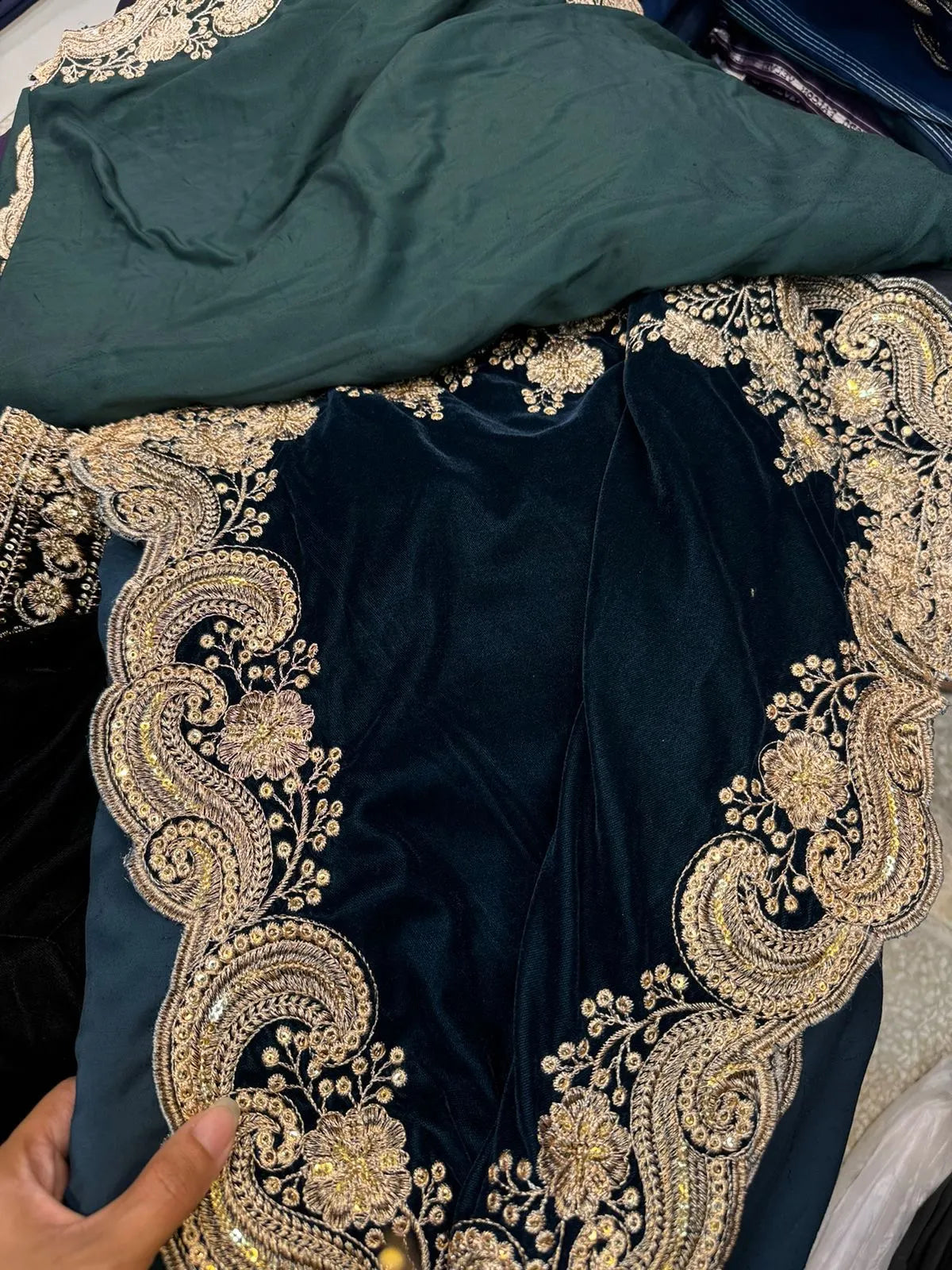 Velvet shawl featuring intricate embellishments and a combination of shimmering tila, sparkling sequins, and delicate stone work. Showcasing exquisite craftsmanship and rich texture, perfect for formal occasions.