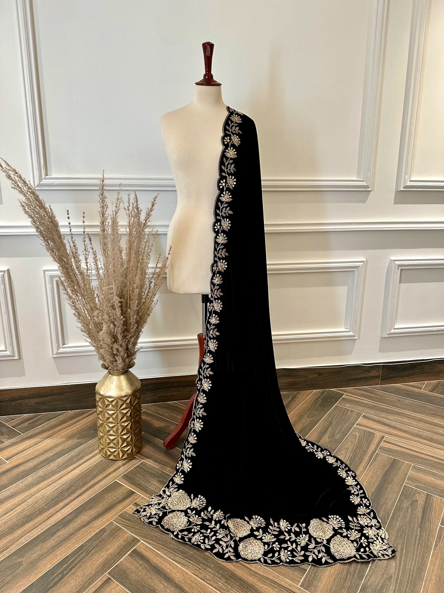 Elevate your style with velvet shawl featuring heavy floral tila and sequin embroidery, floral cutwork borders, and decorative floral bunches on pallu. Ideal for festive events.