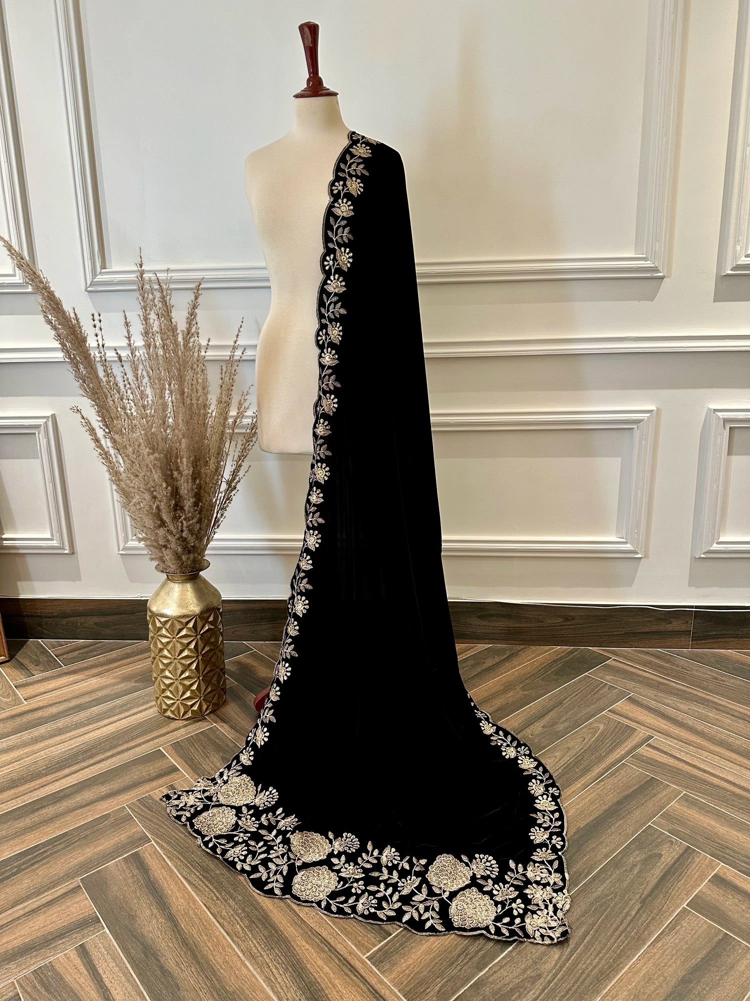 Elevate your style with velvet shawl featuring heavy floral tila and sequin embroidery, floral cutwork borders, and decorative floral bunches on pallu. Ideal for festive events.