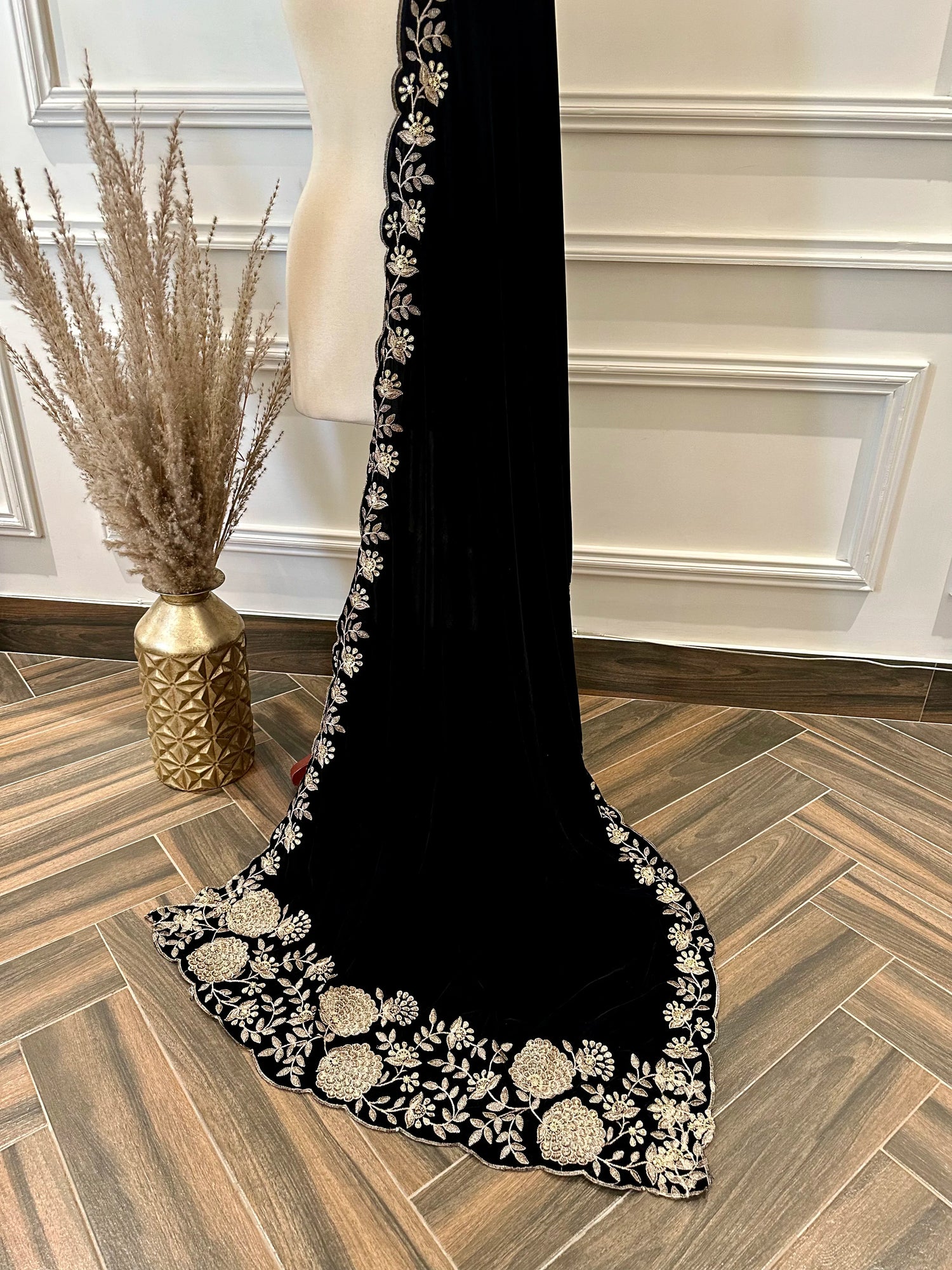 Elevate your style with velvet shawl featuring heavy floral tila and sequin embroidery, floral cutwork borders, and decorative floral bunches on pallu. Ideal for festive events.