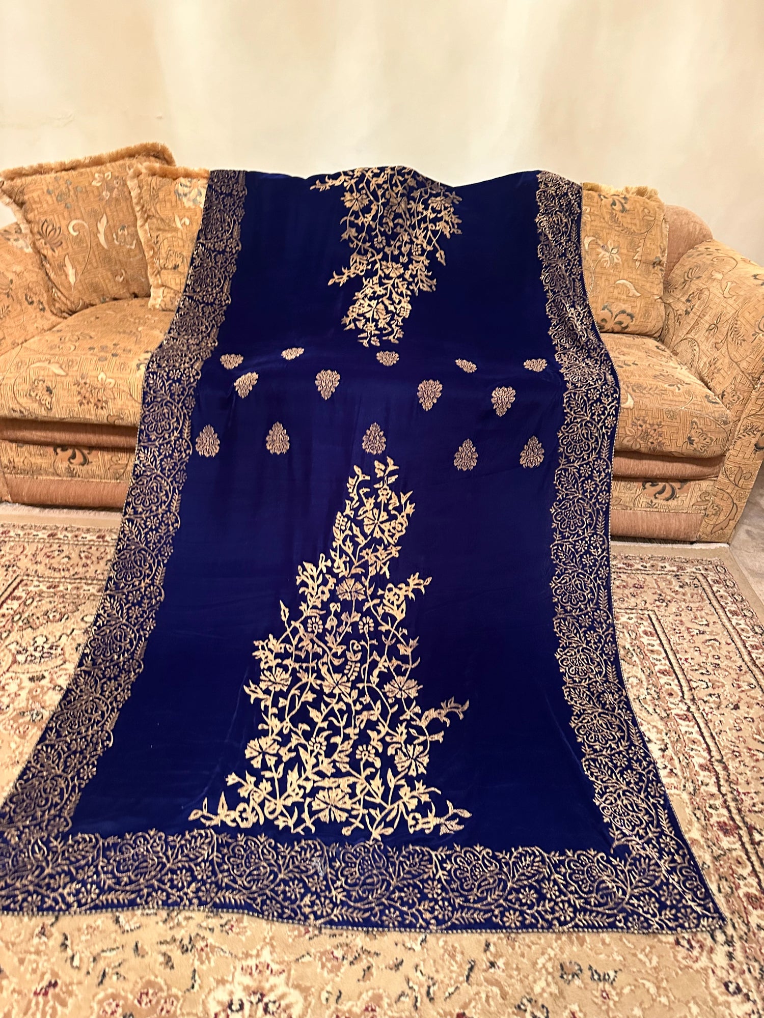 Royal blue velvet shawl with intricate antique gold tilla embroidery with heavy border and premium fabric texture, ideal for festive events.