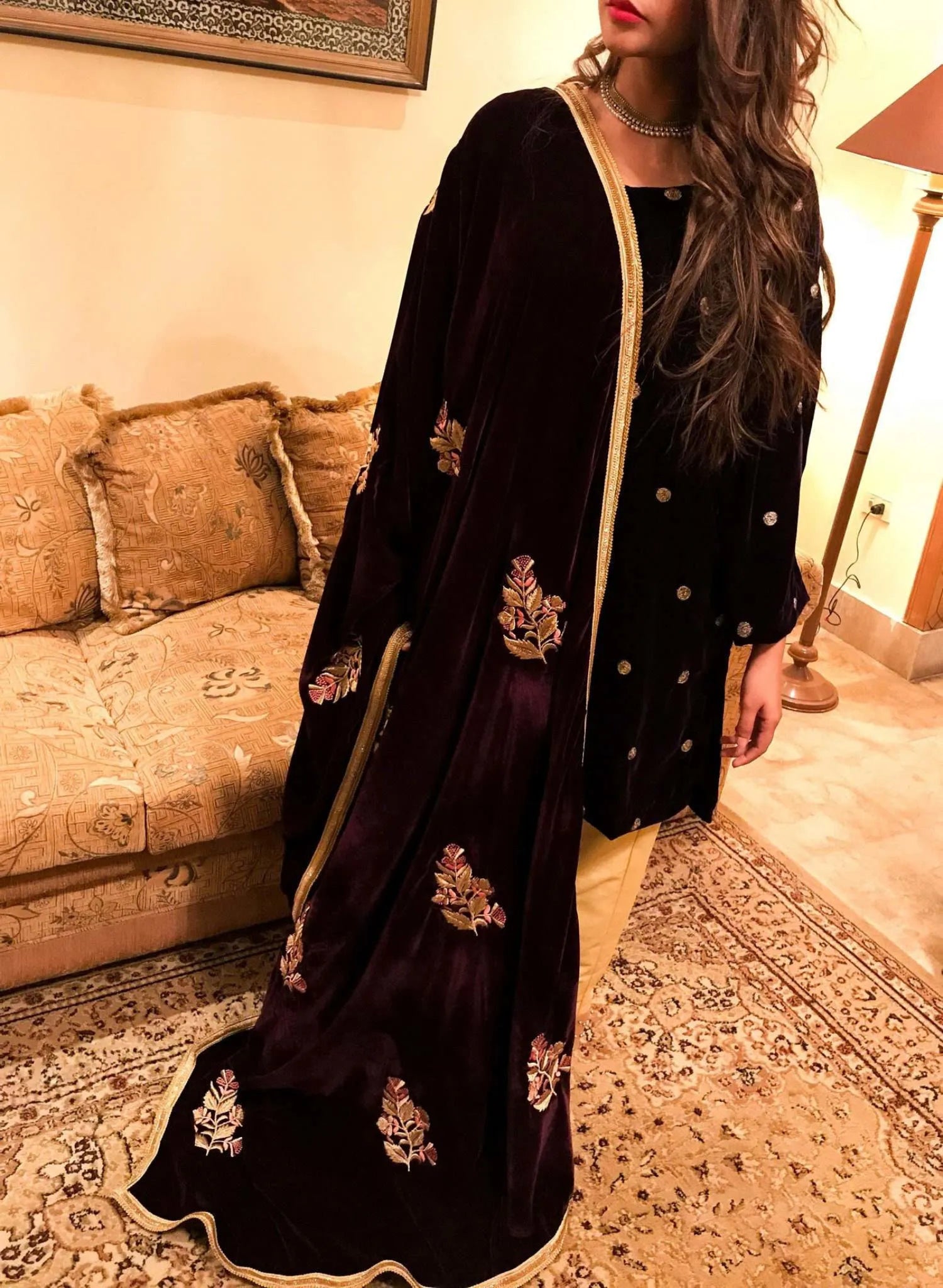 A luxurious velvet shawl featuring intricate gold embroidery and floral designs, exuding elegance, highlighting refined craftsmanship  and sophistication.