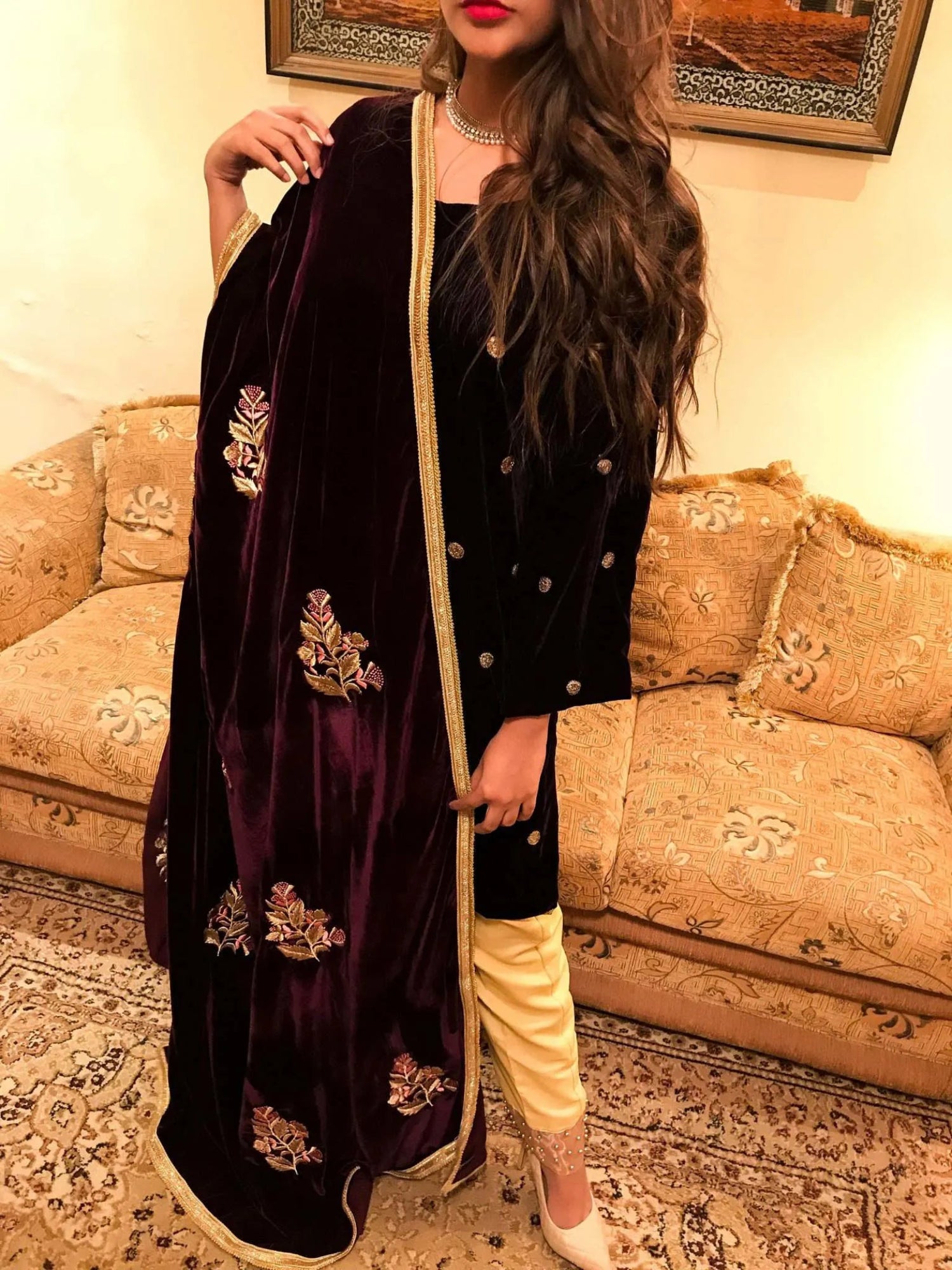 A luxurious velvet shawl featuring intricate gold embroidery and floral designs, exuding elegance, highlighting refined craftsmanship  and sophistication.